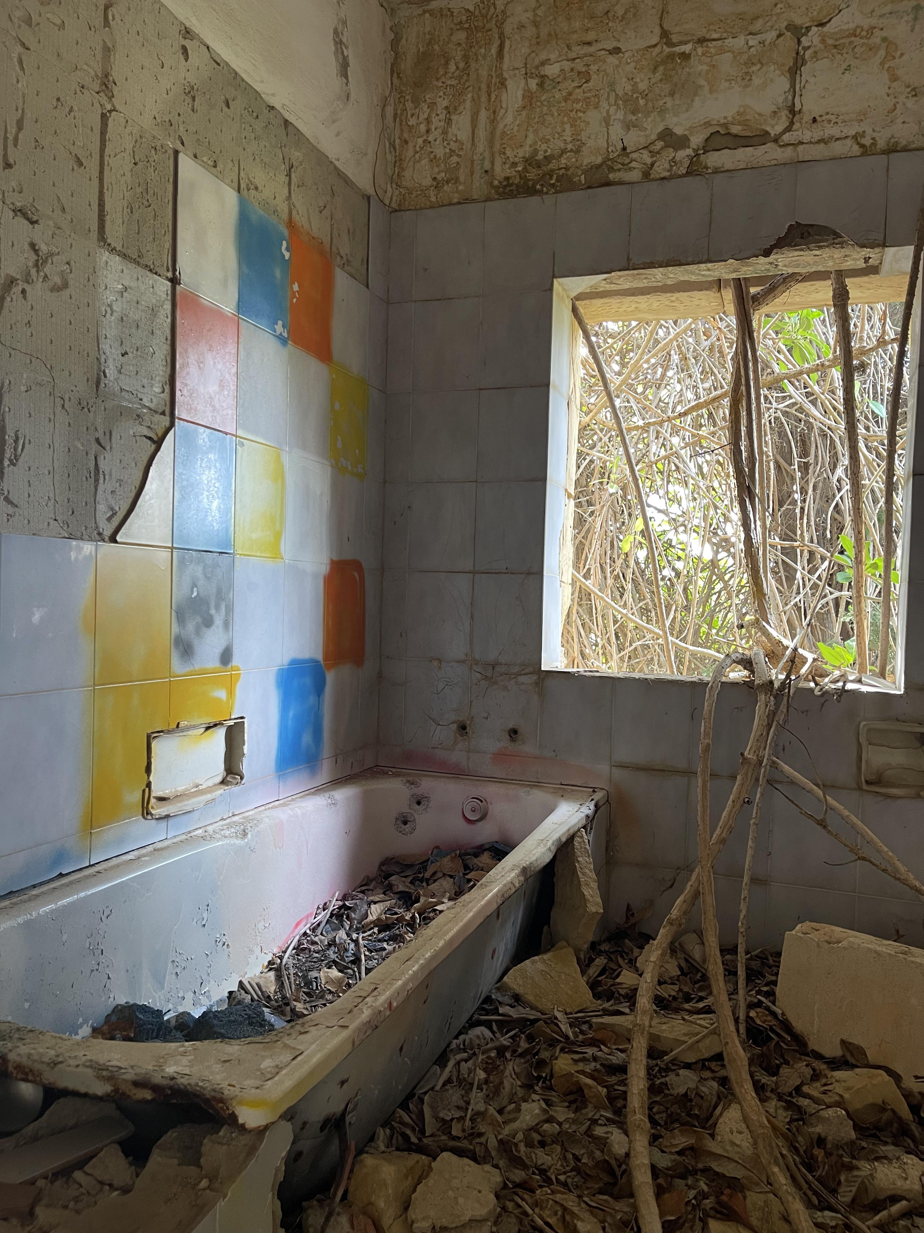 Urban exploration of a derelict 5 storey concrete building in Malta with graffiti and rubble.