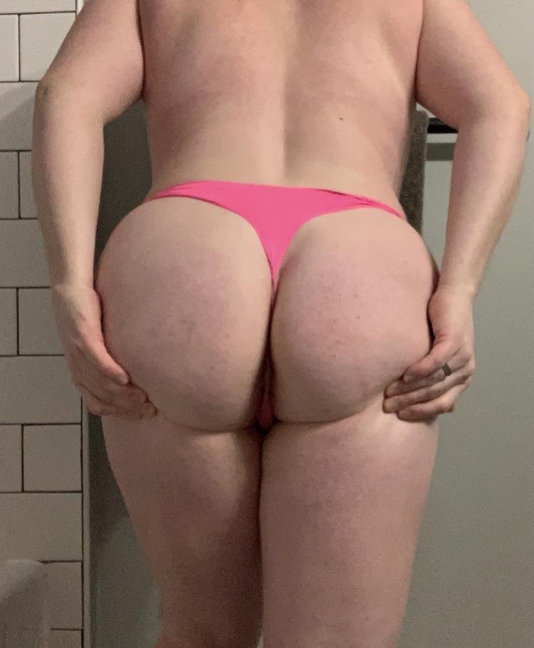 Thick white woman in pink and white thongs posing for wifebutt pelfies in a bedroom and bathroom