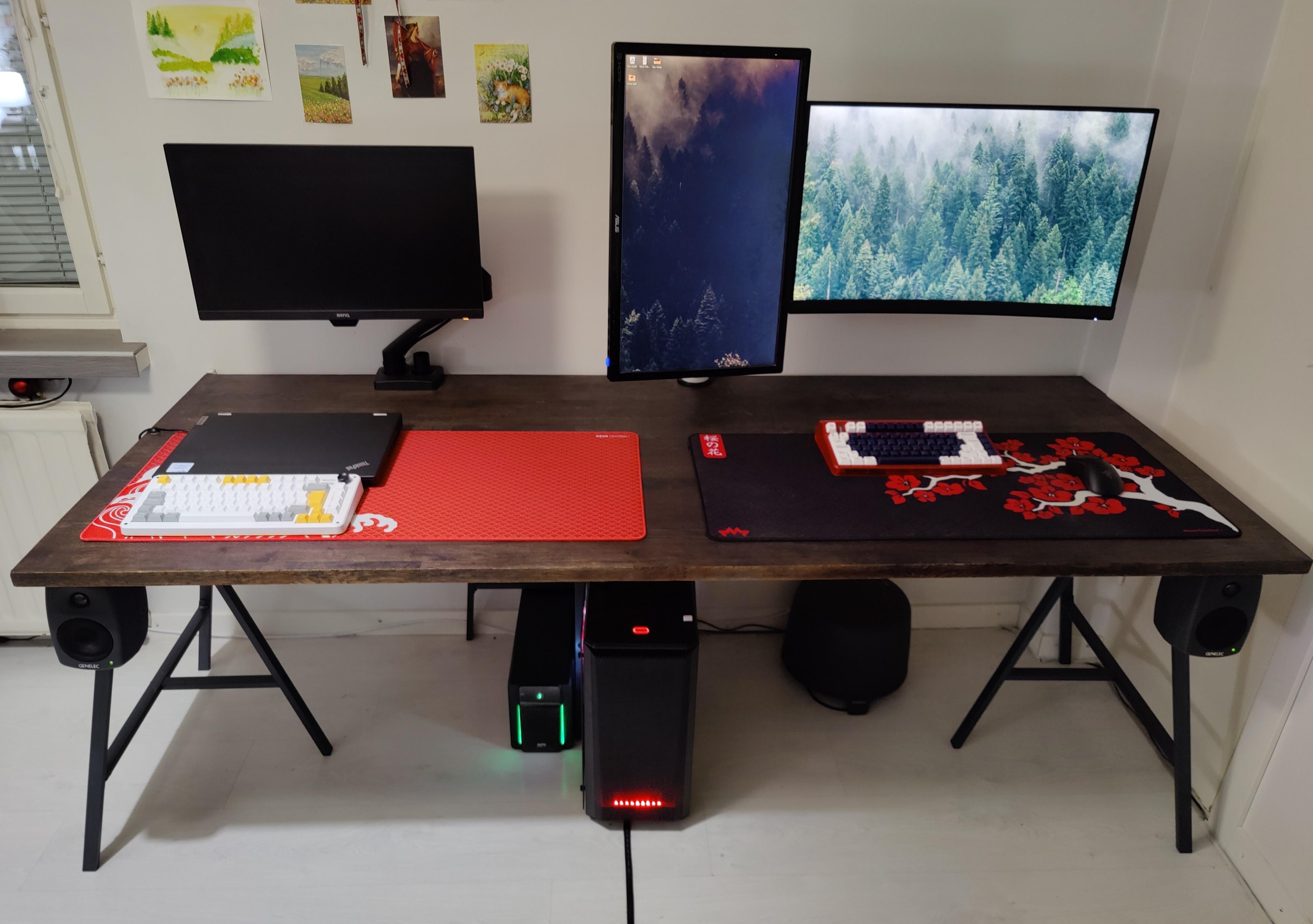 Gaming PC setup with an Optoma projector casting a forest landscape onto a living room wall near a black leather sofa