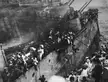 Men crossing from the HMS Prince of Wales to the HMS Express on cables and gangplanks. Their ship and the HMS Repulse were attacked and sunk by 85 Japanese bombers. 840 men lost their lives. [2390x1805]