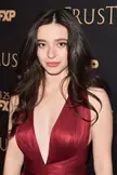 Mikey Madison in a red metallic V-neck dress at a red carpet event