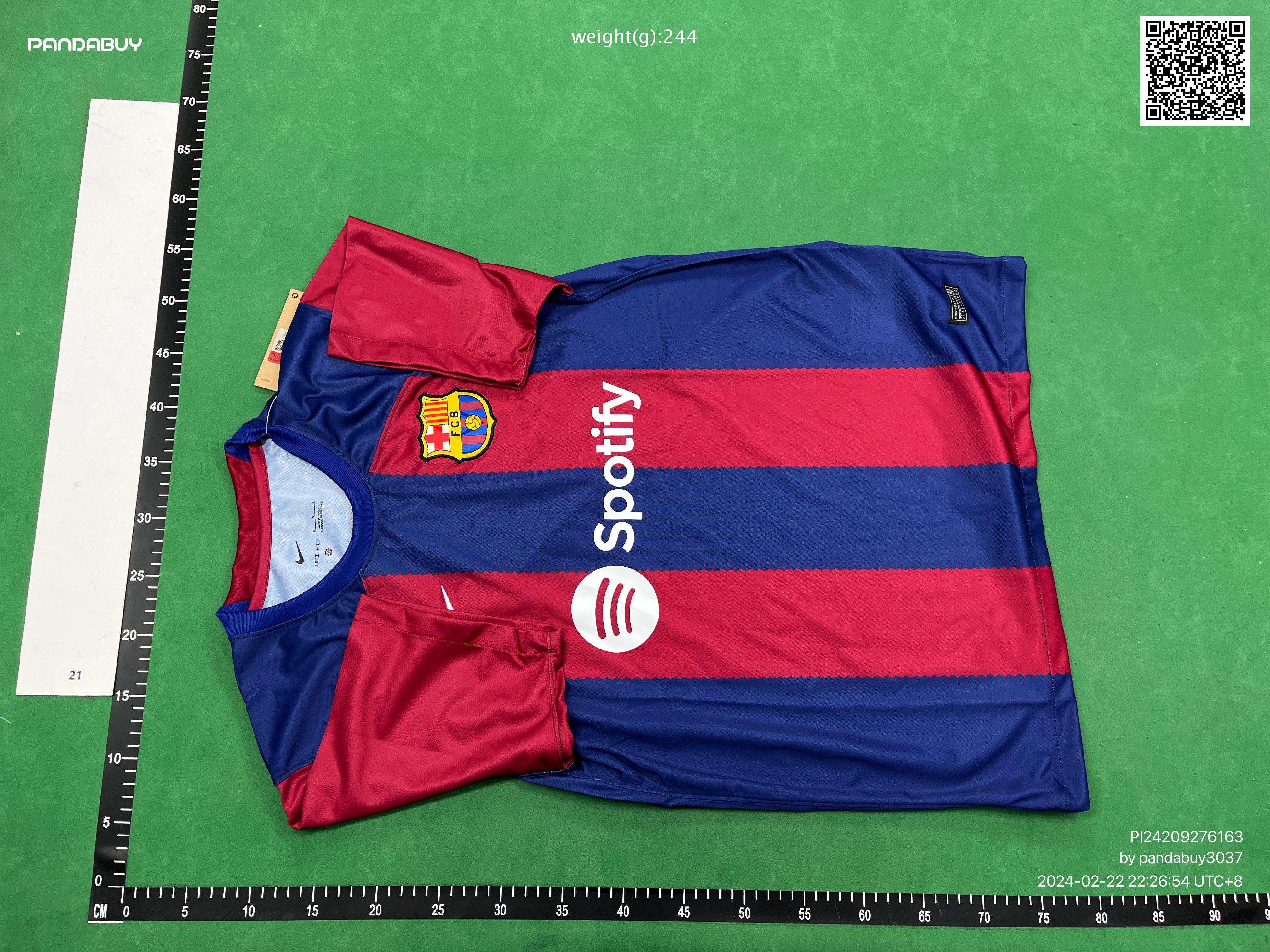 Pandabuy haul of streetwear including Gallery Dept, Spotify, and FC Barcelona shirts and sneakers on a green background
