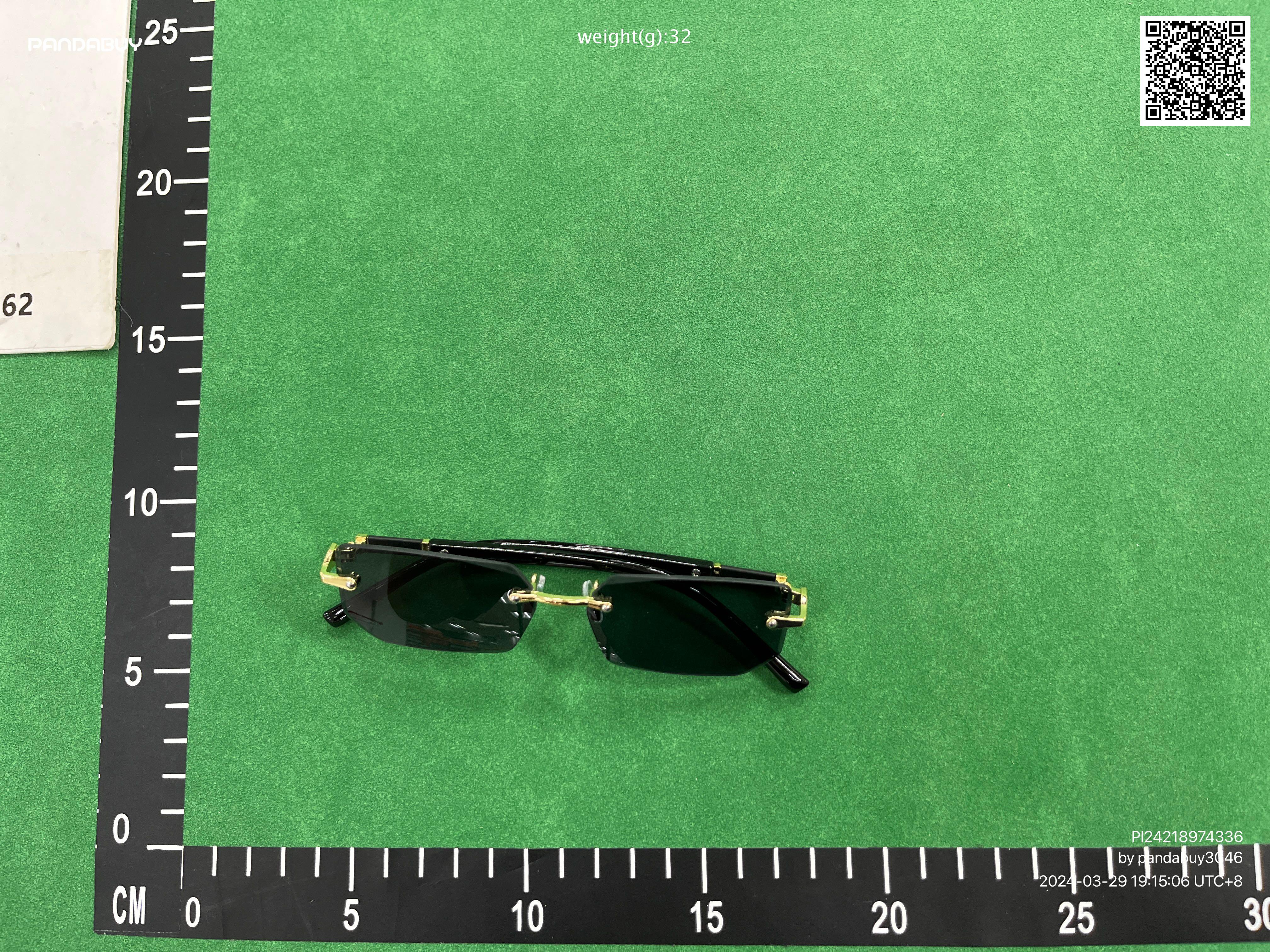 Pandabuy haul of streetwear including Gallery Dept, Spotify, and FC Barcelona shirts and sneakers on a green background
