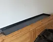 No screw headboard shelf attachment that is pushed against the wall (There's a 90 degree angled supporting leg that the headboard pushes into) to use instead of a nightstand. It stores my glasses, phone and books.