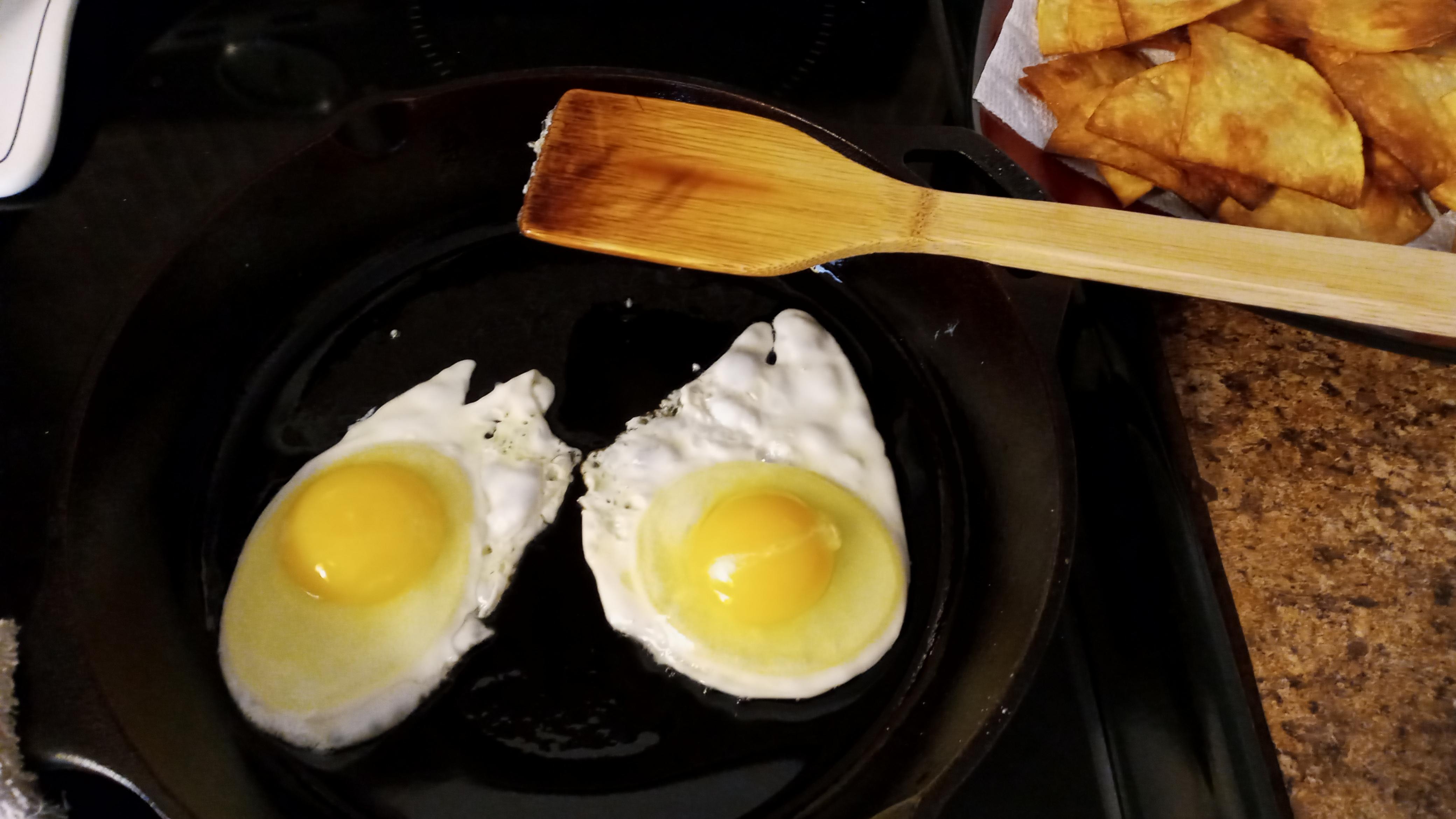 Cast iron chilaquiles breakfast with fried eggs and salsa