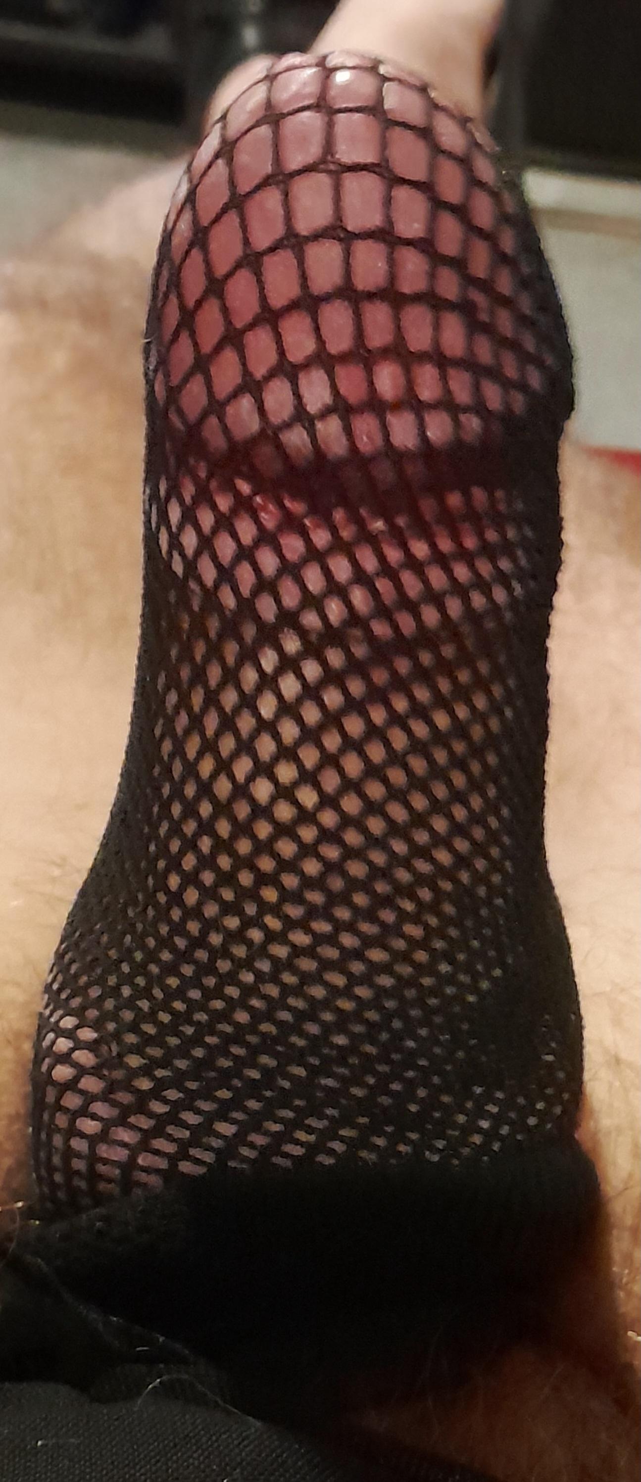 Close-up of white cum on black mesh clothing