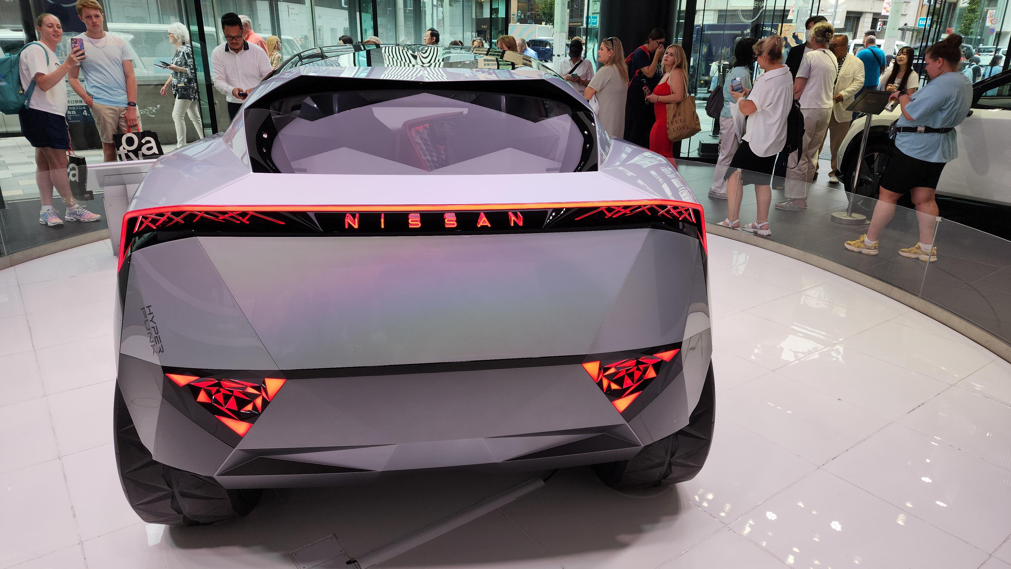 Nissan Cyber Punk concept car and interior at Nissan Crossing showroom with a group of people