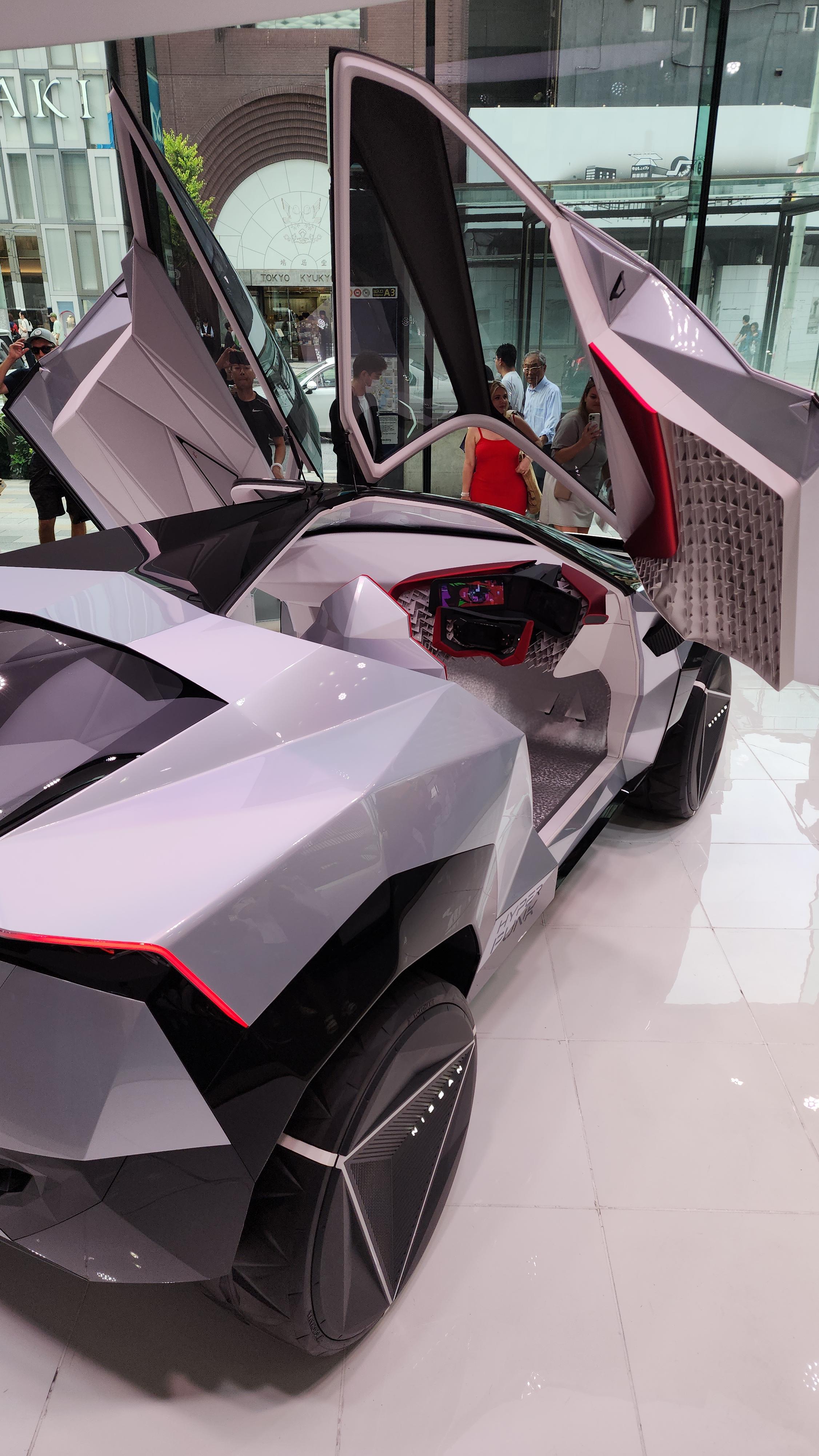 Nissan Cyber Punk concept car and interior at Nissan Crossing showroom with a group of people