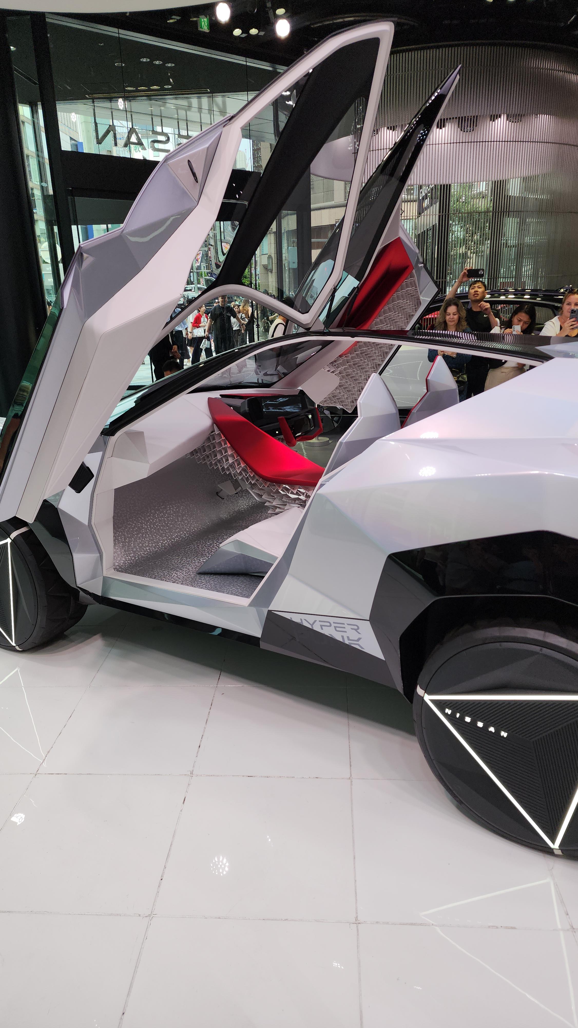 Nissan Cyber Punk concept car and interior at Nissan Crossing showroom with a group of people