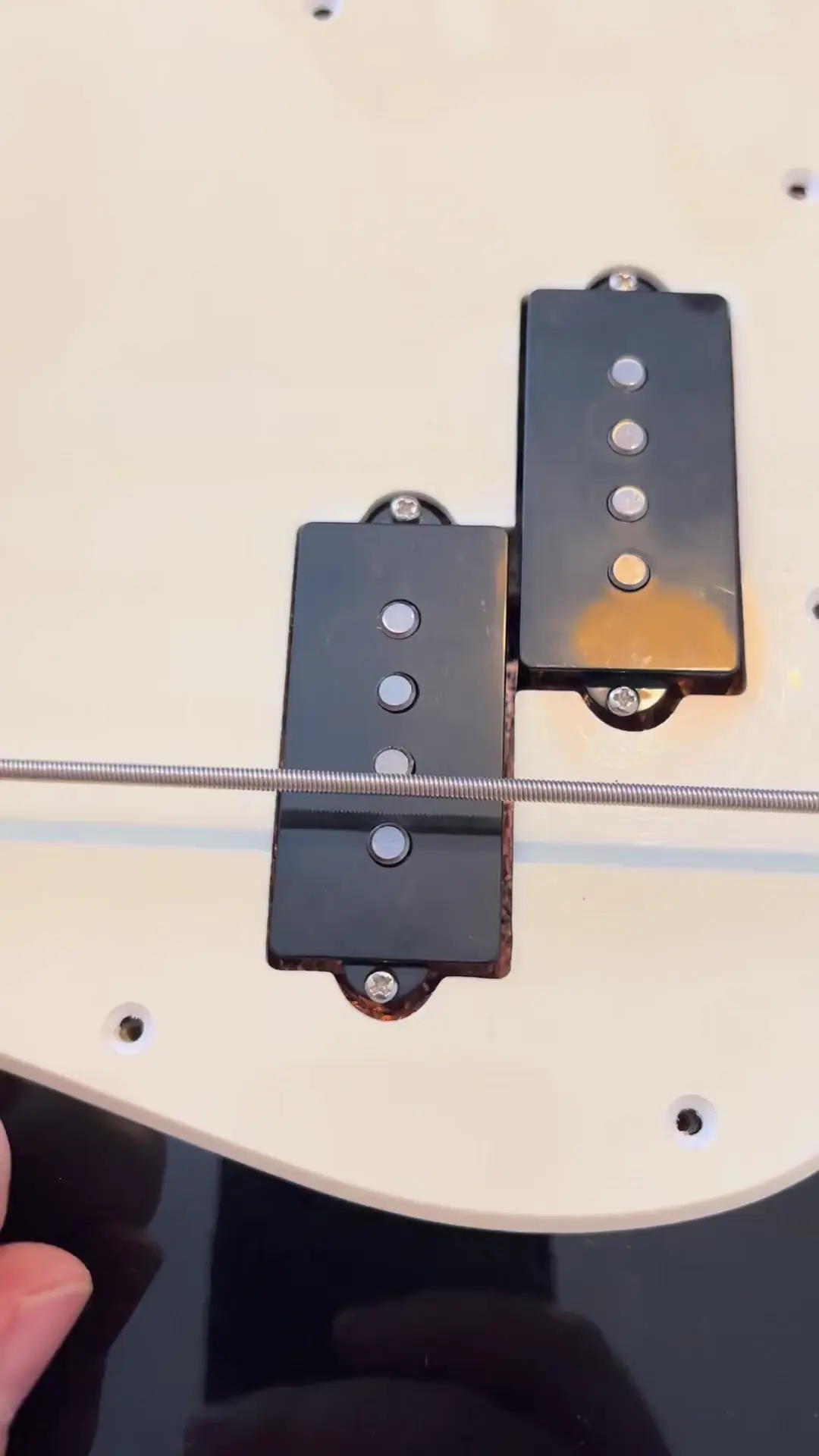 P-bass pickup humming when touching the plastic cover
