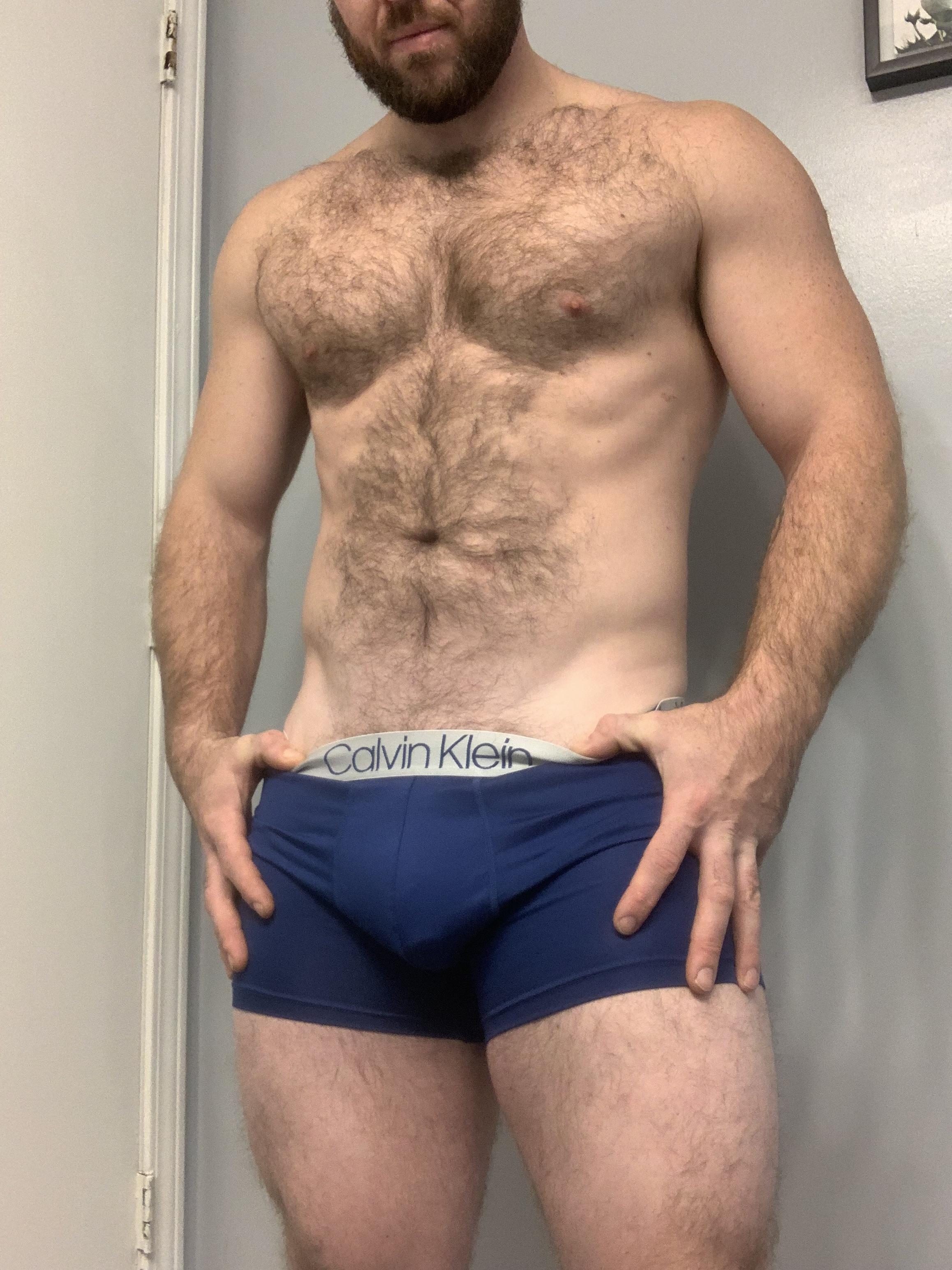 Muscular white DILF with a hairy chest and stomach posing naked with a big uncut cock