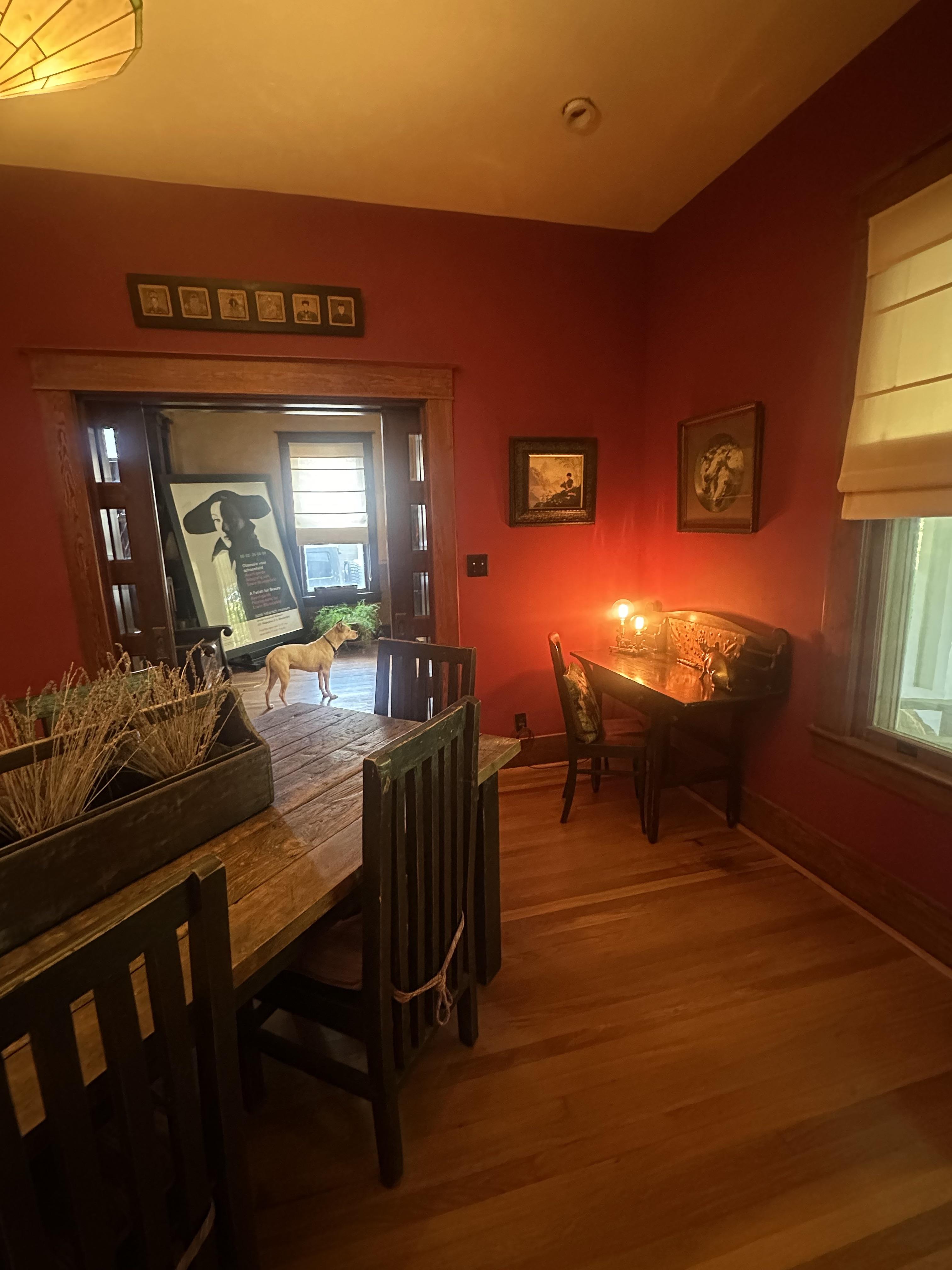 Male living space featuring a dining room, bedroom, living room, patio, sunroom, study, and a dog with oil painting art.