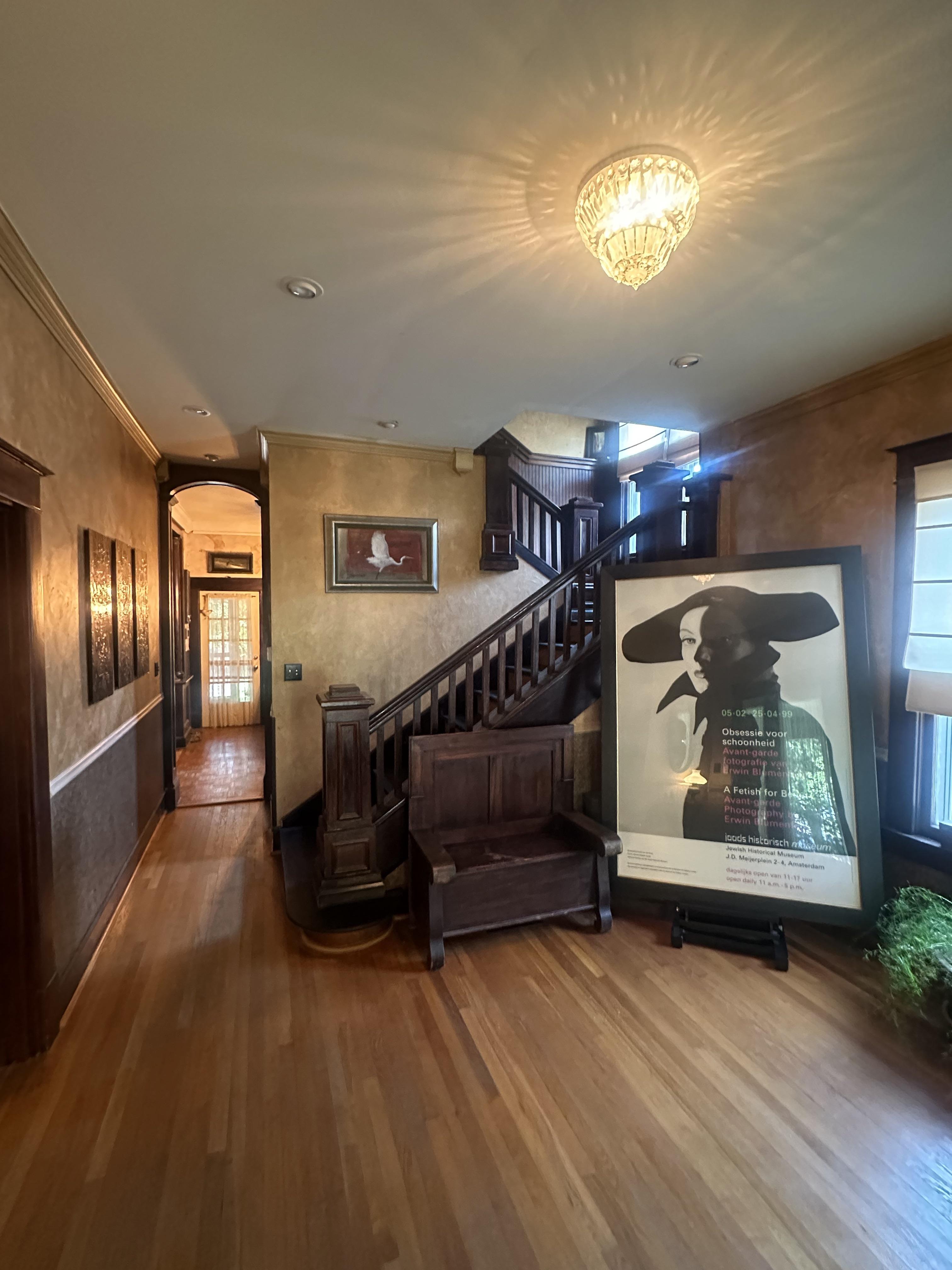 Male living space featuring a dining room, bedroom, living room, patio, sunroom, study, and a dog with oil painting art.