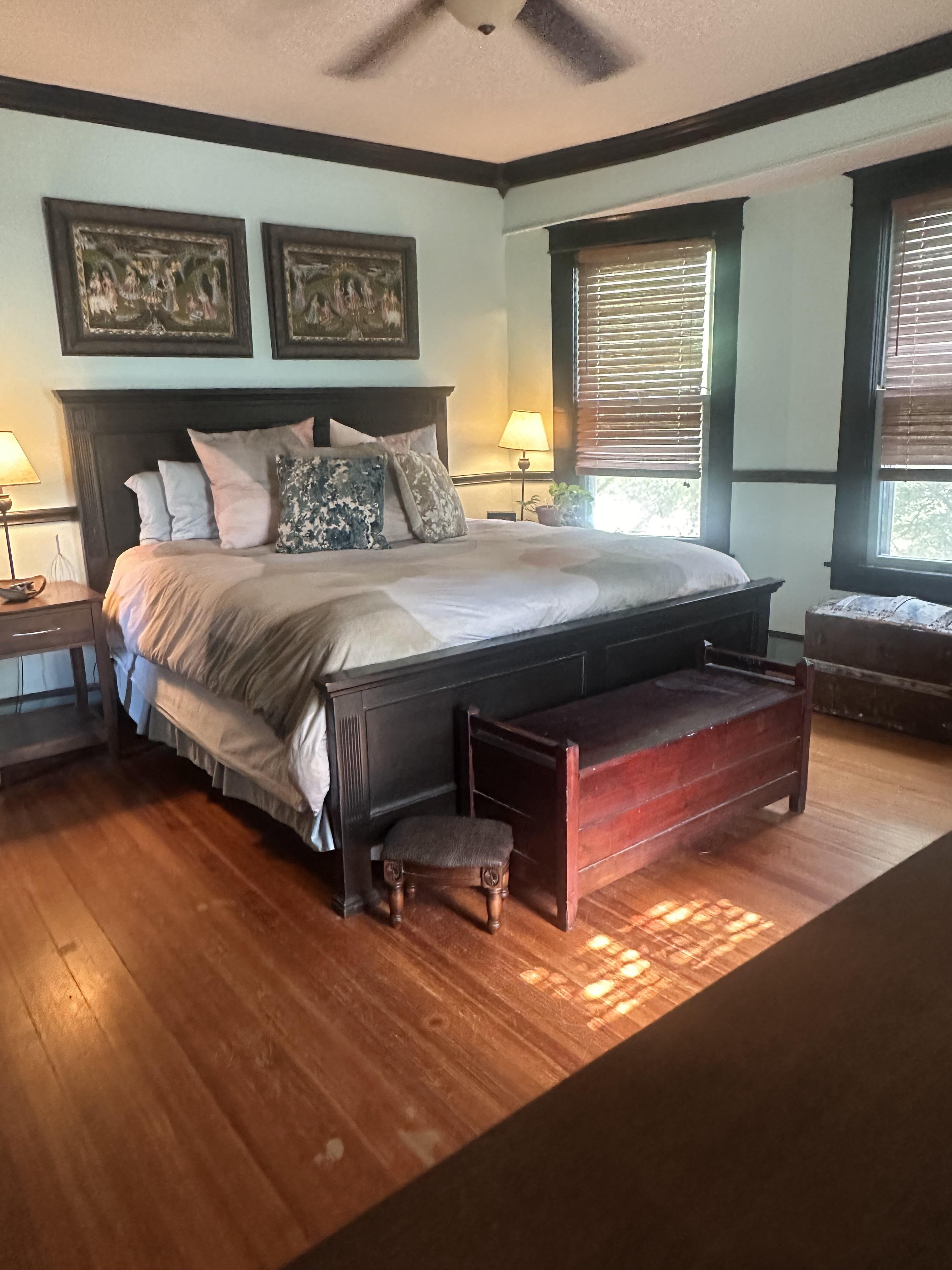 Male living space featuring a dining room, bedroom, living room, patio, sunroom, study, and a dog with oil painting art.