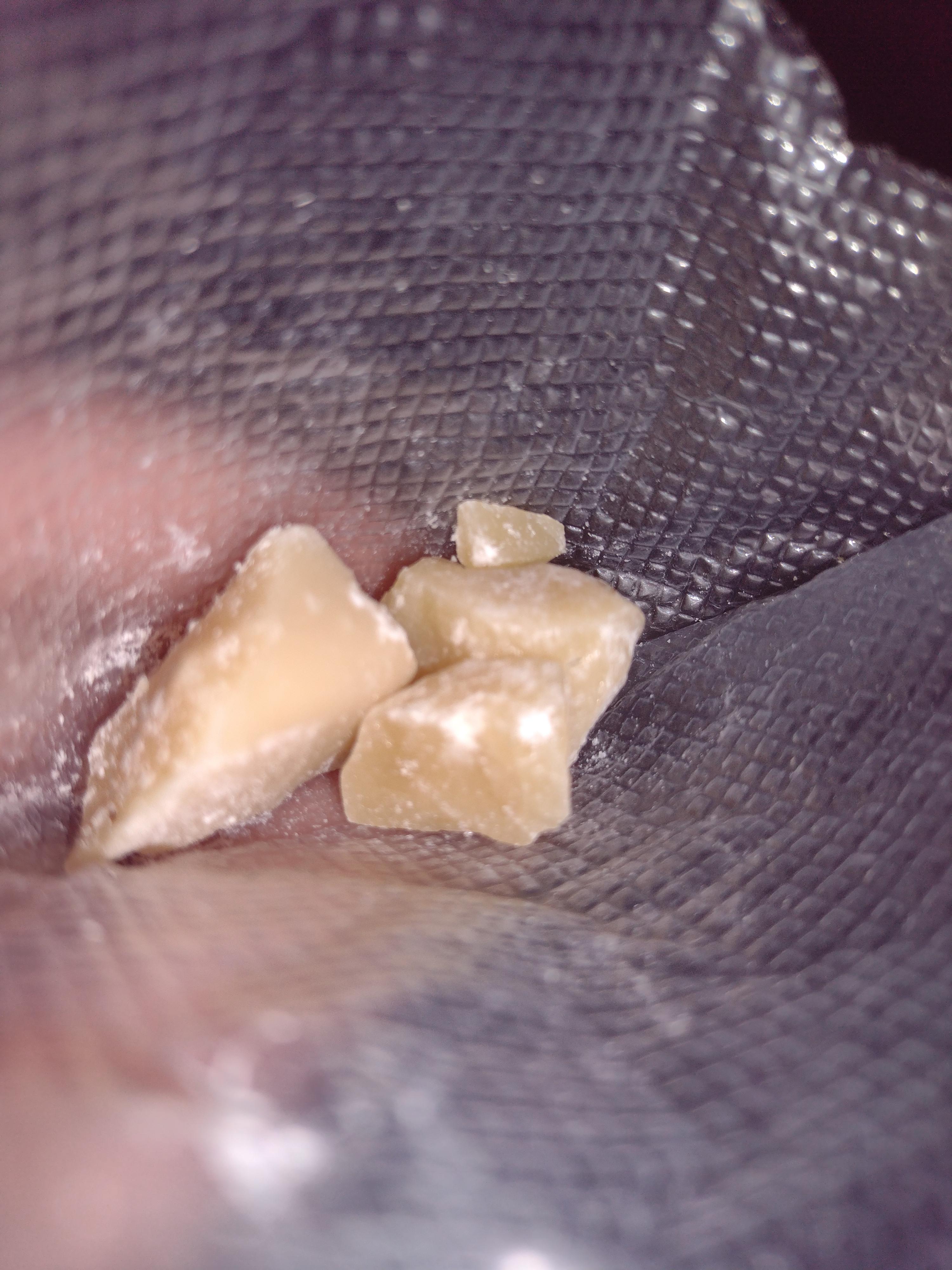 Close-up of white, crystalline synthetic drugs with a glazed appearance.