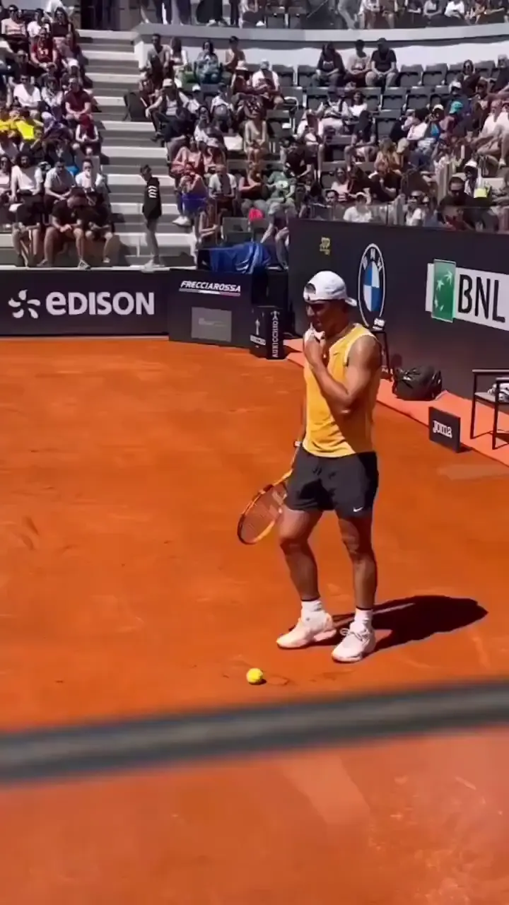 Rafael Nadal casually returning balls.