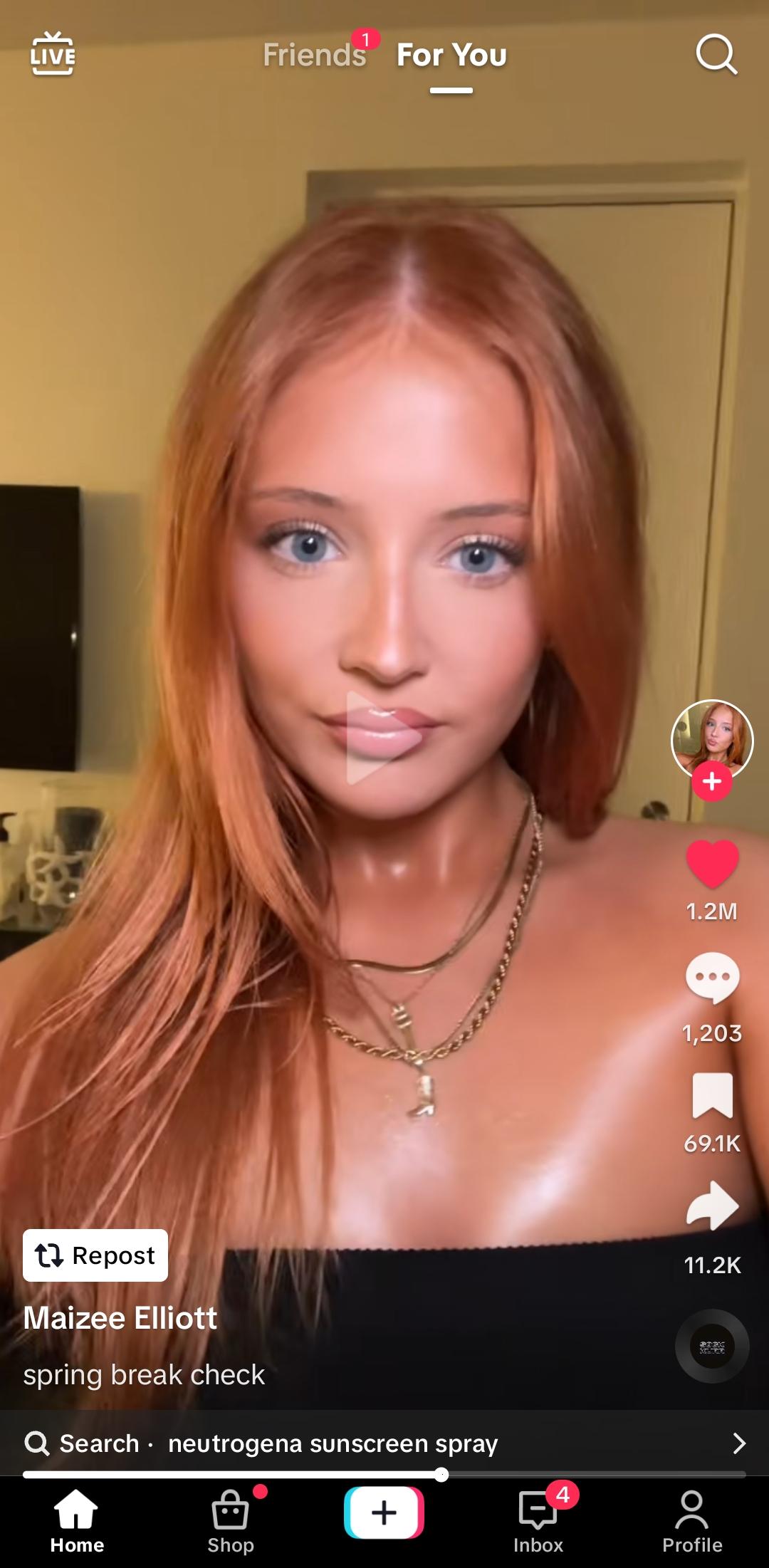 Maizee Elliott with brown, red, and blonde hair styles wearing a black lace top, beige tube top, and white top.