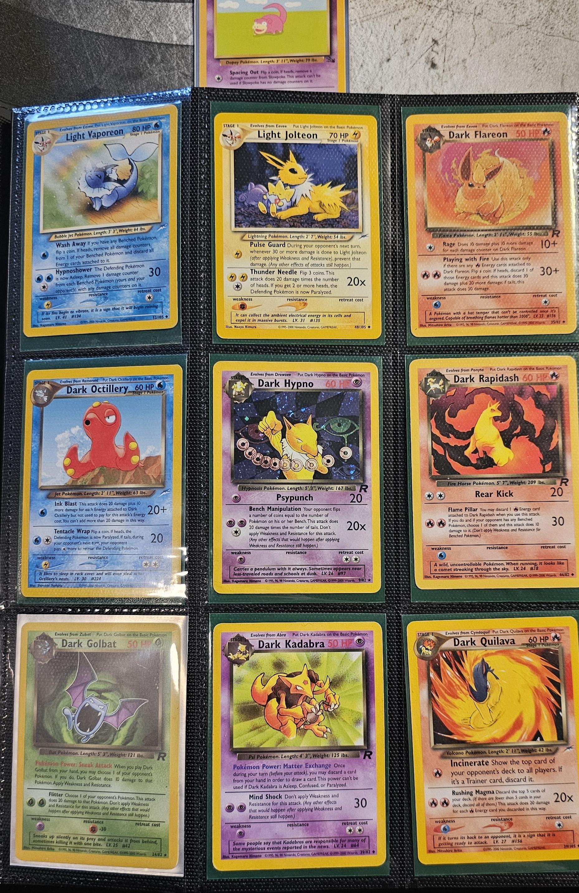 Pokémon trading cards and Misty Pokémon fan art organized in a card binder on the floor.