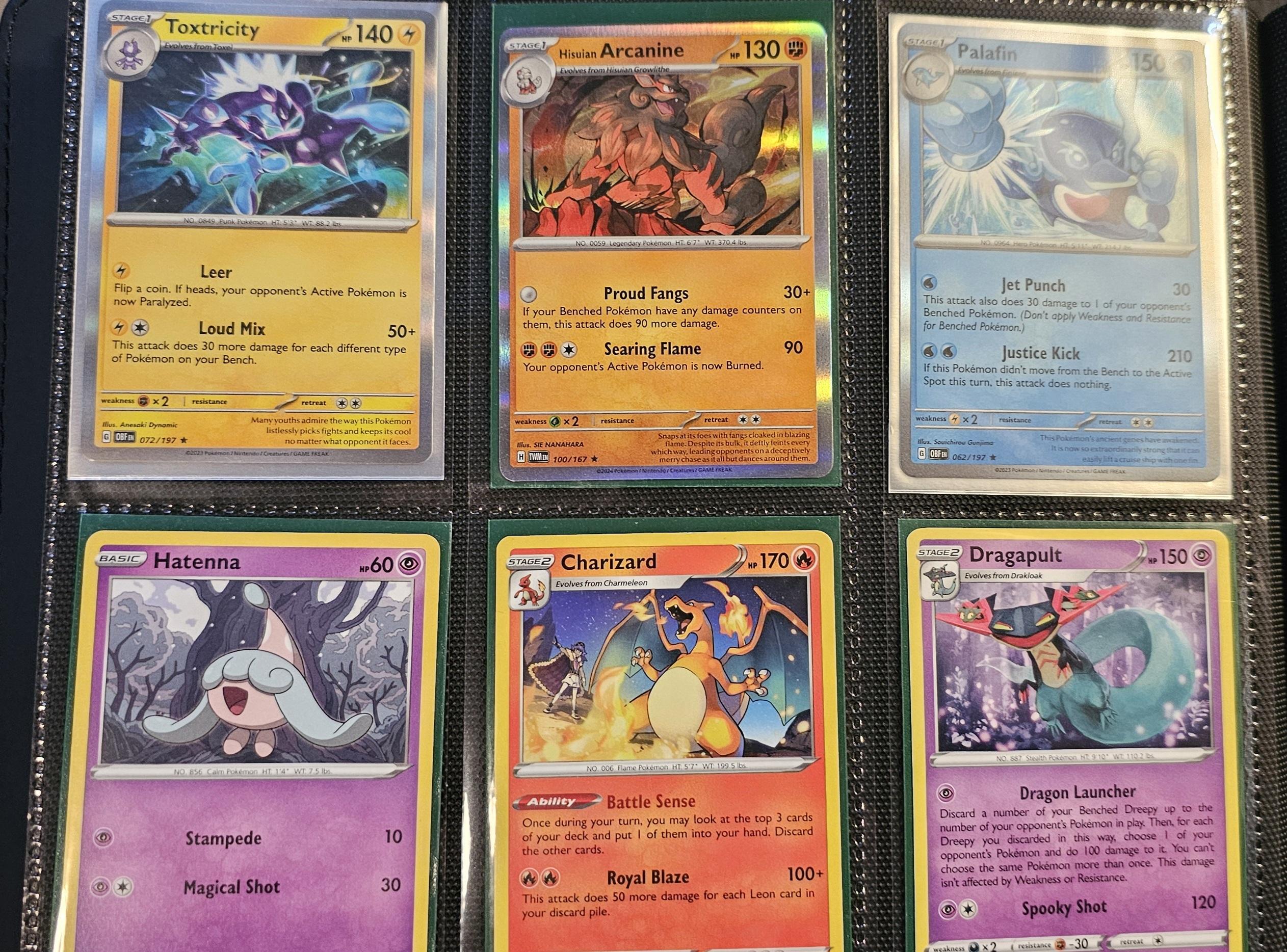 Pokémon trading cards and Misty Pokémon fan art organized in a card binder on the floor.