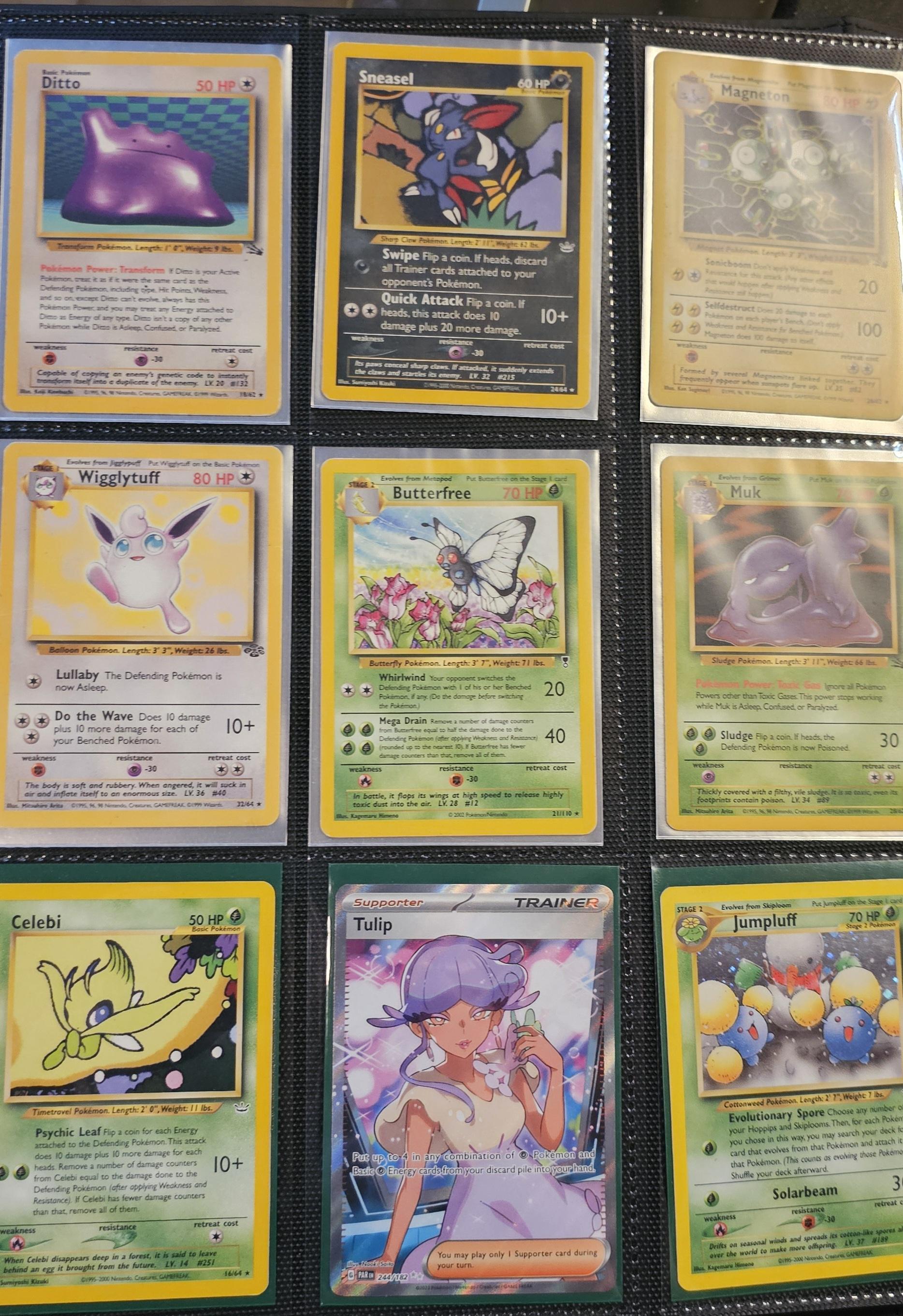 Pokémon trading cards and Misty Pokémon fan art organized in a card binder on the floor.
