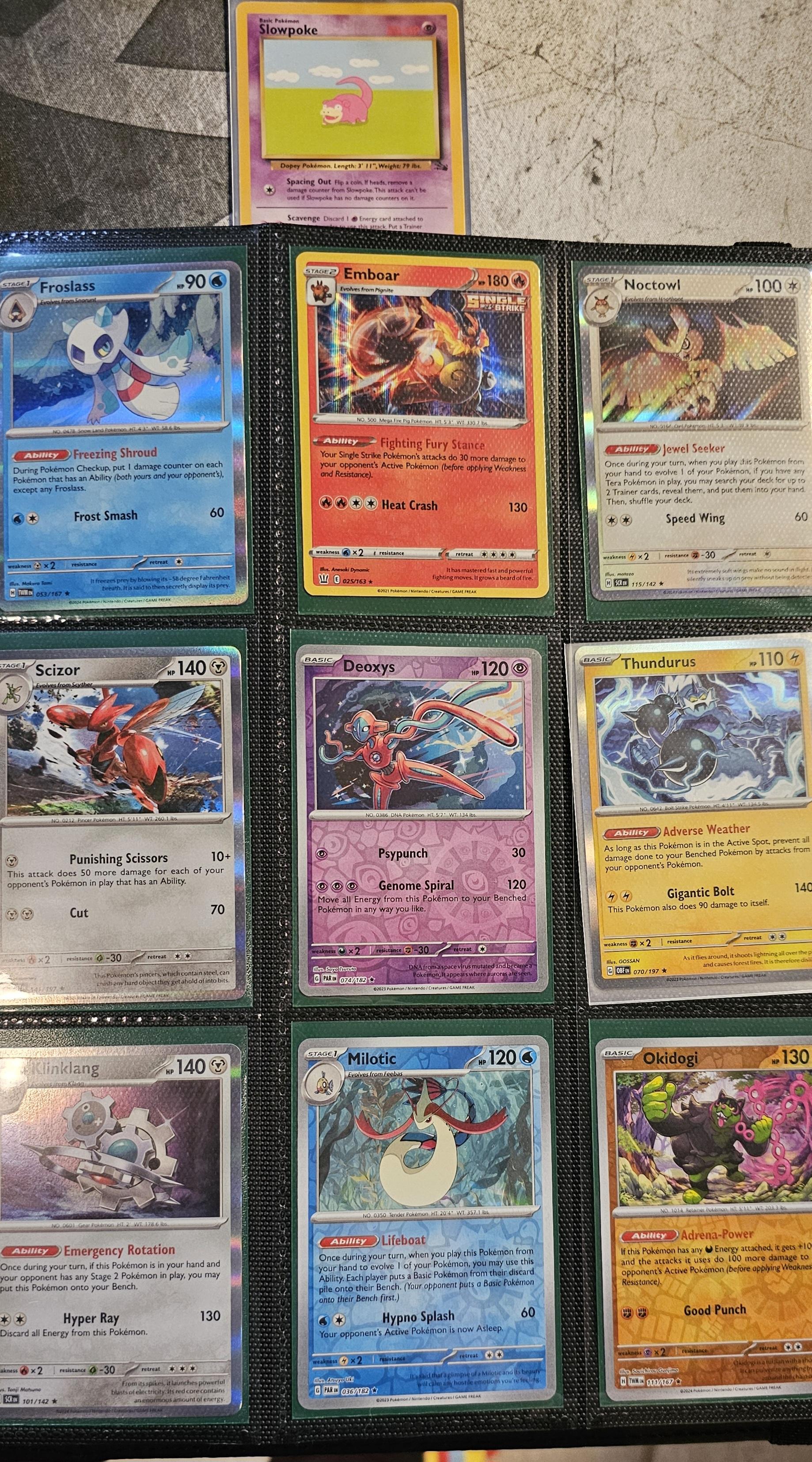 Pokémon trading cards and Misty Pokémon fan art organized in a card binder on the floor.