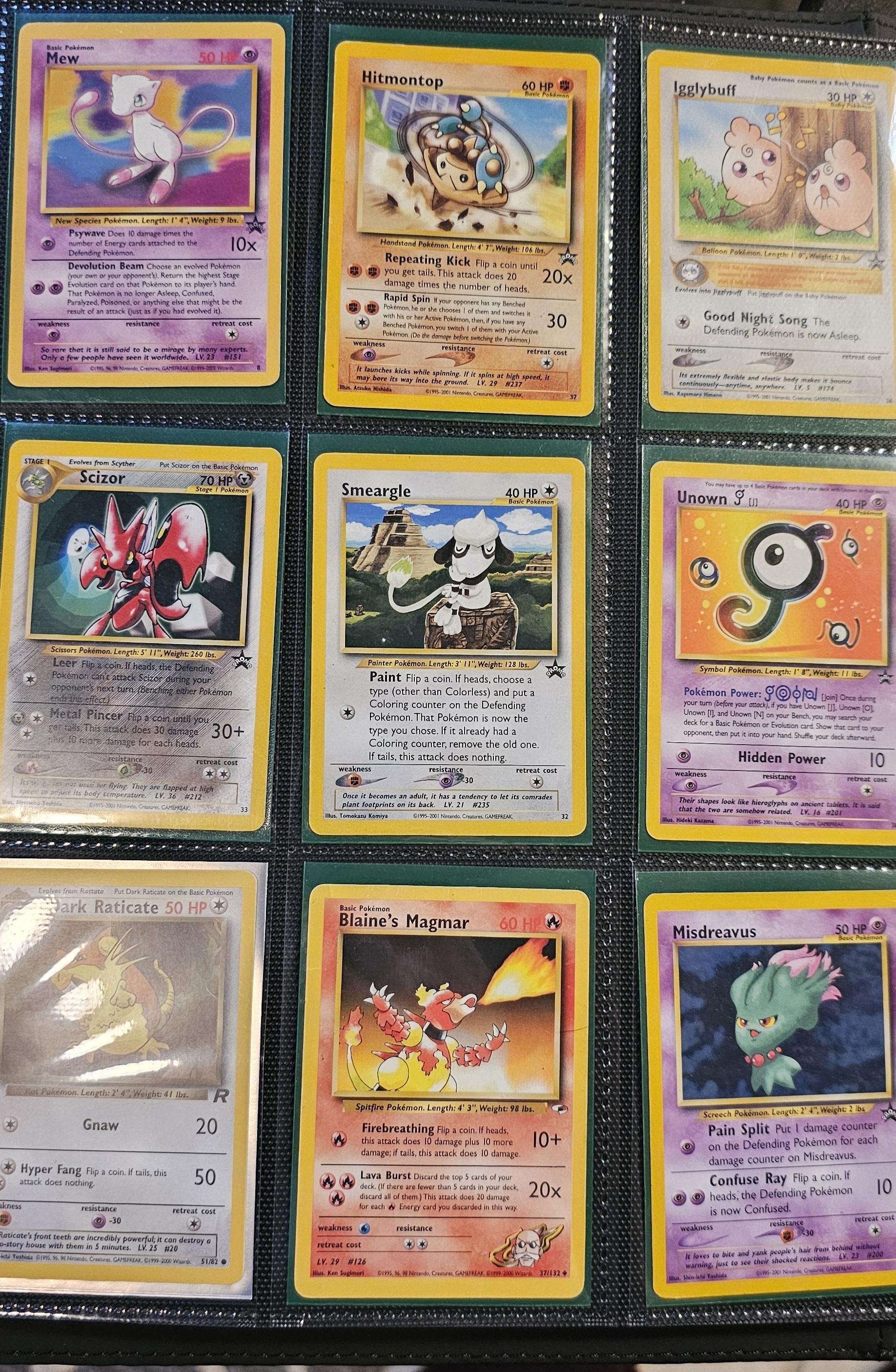 Pokémon trading cards and Misty Pokémon fan art organized in a card binder on the floor.