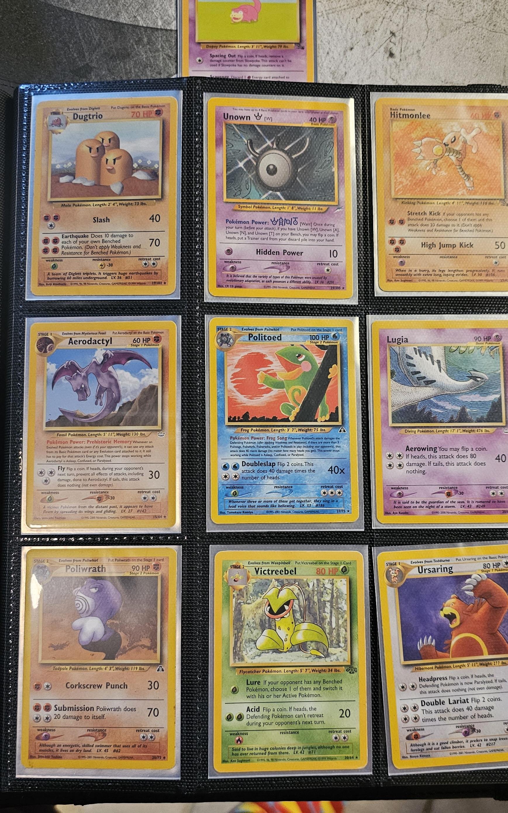 Pokémon trading cards and Misty Pokémon fan art organized in a card binder on the floor.