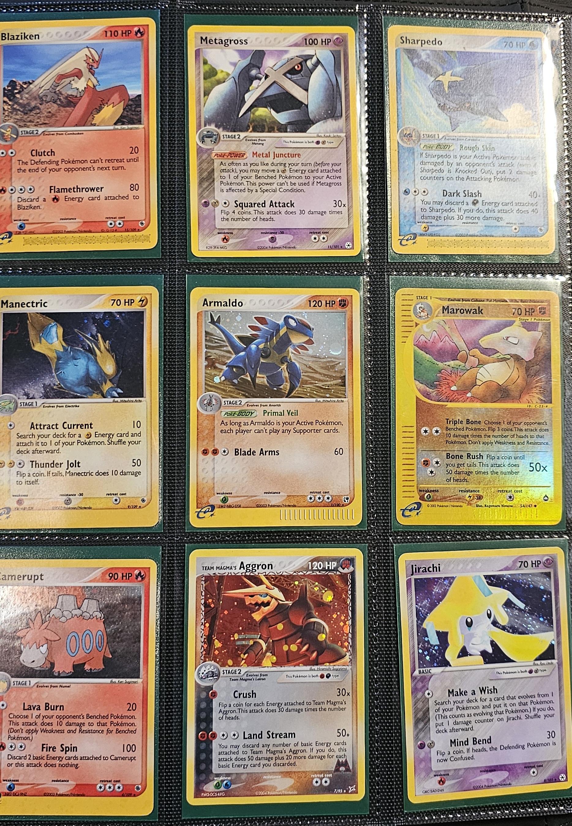 Pokémon trading cards and Misty Pokémon fan art organized in a card binder on the floor.