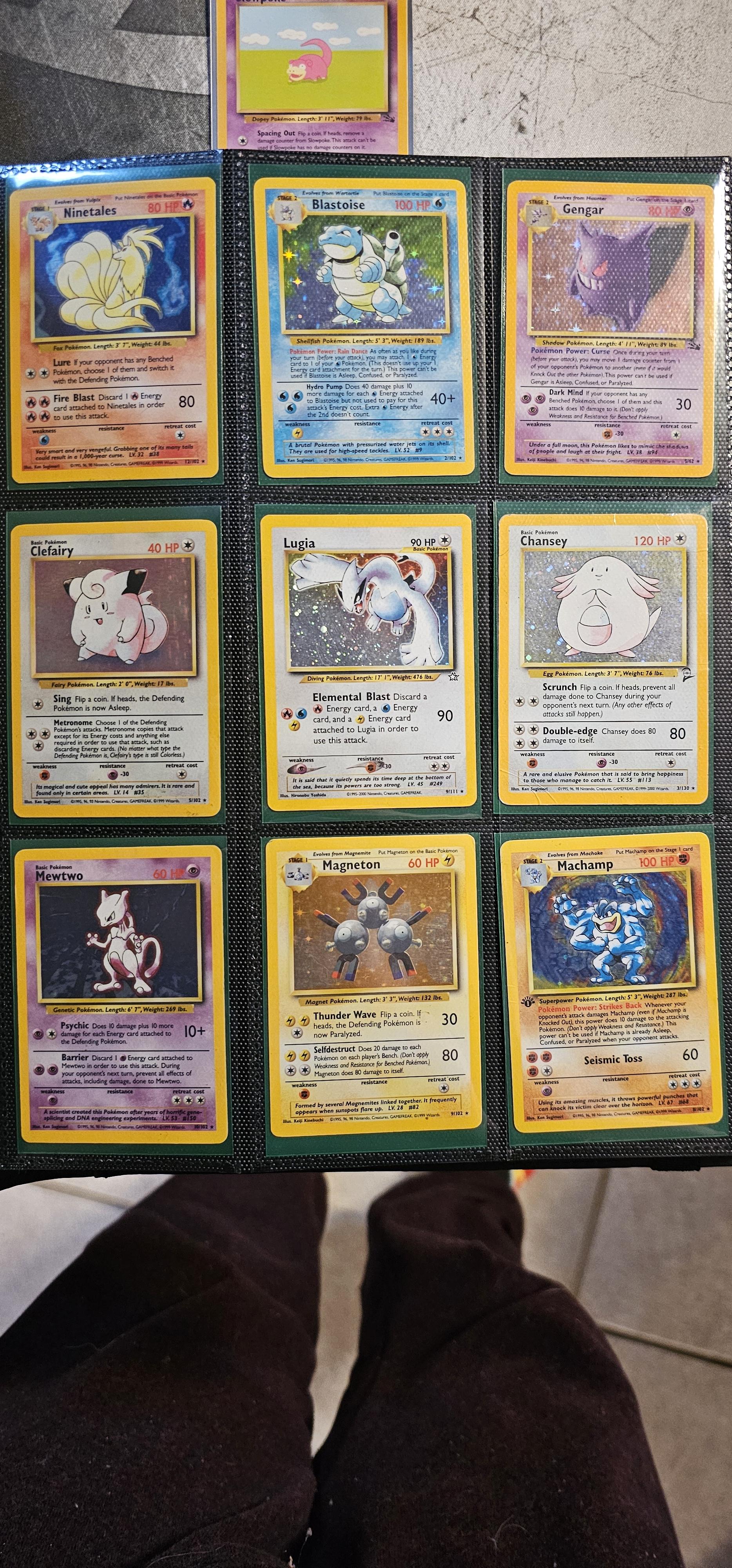 Pokémon trading cards and Misty Pokémon fan art organized in a card binder on the floor.