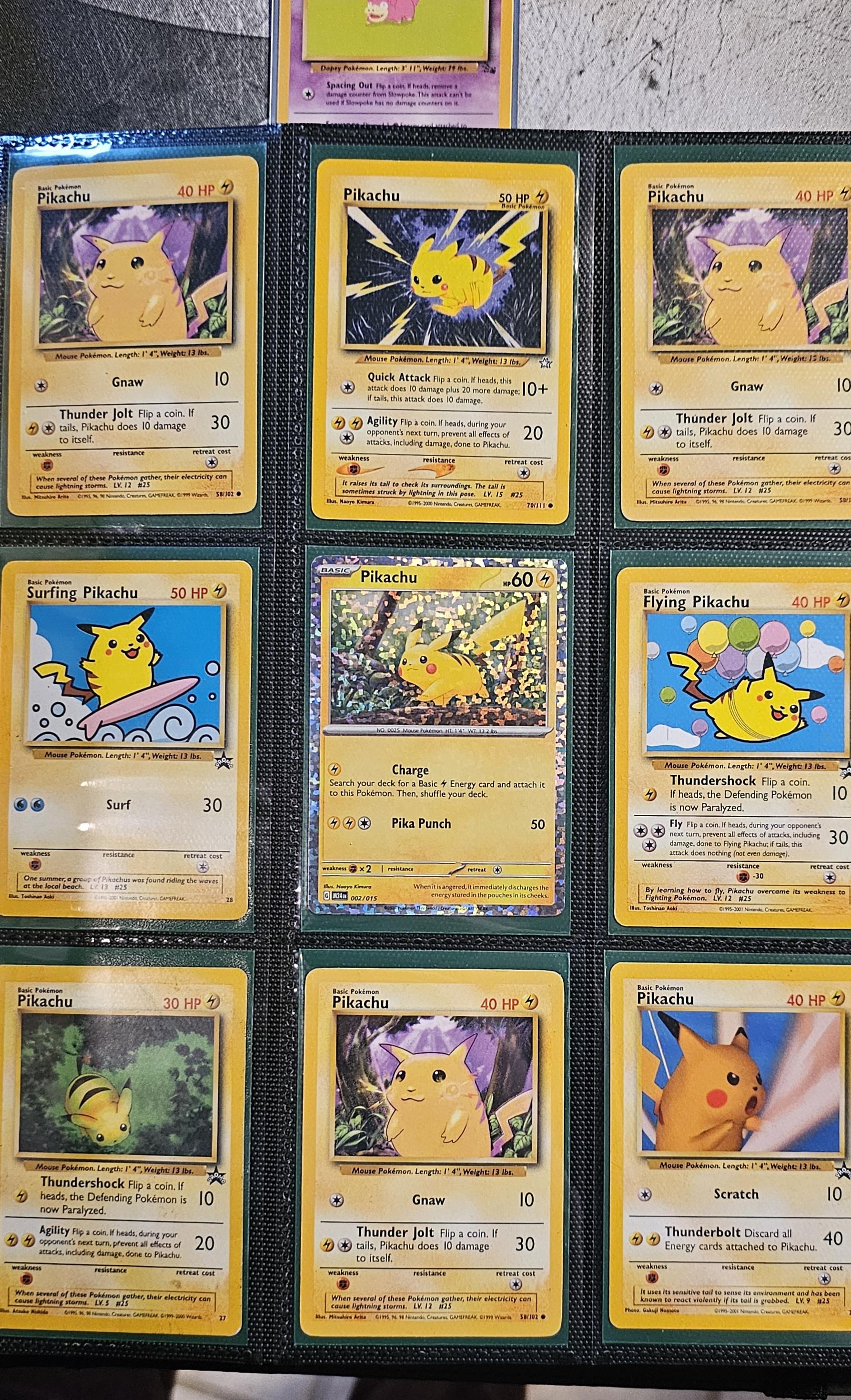 Pokémon trading cards and Misty Pokémon fan art organized in a card binder on the floor.