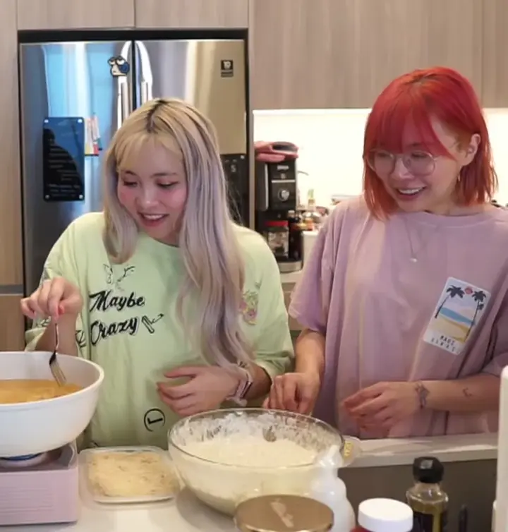 Stacking noodles on her friend's head!