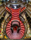 Staircase at Livraria Lello e Irmao, Porto, Portugal. Art nouveau style, designed by engineer Francisco Xavier Esteves around 1906. [1080x837] [OC]