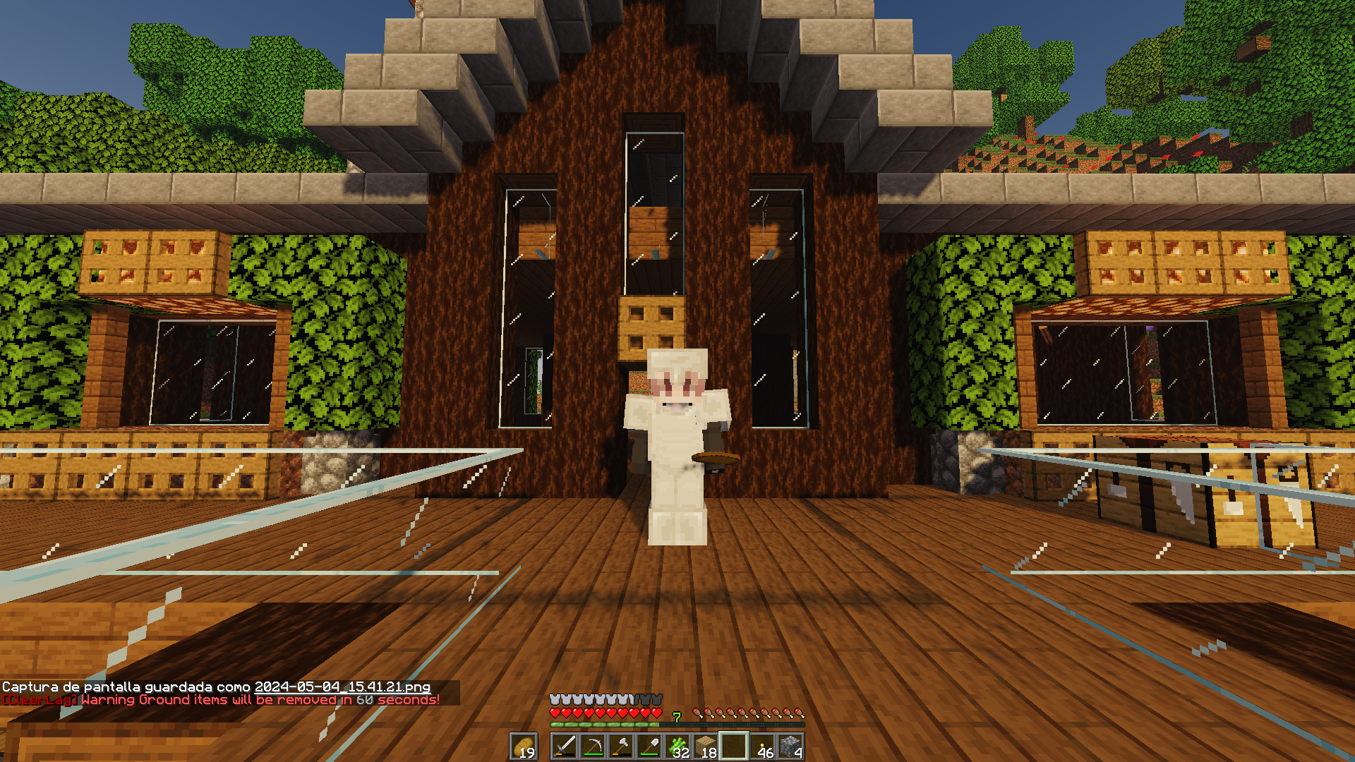 Minecraft player character in a white and purple outfit standing before a cute wooden house build