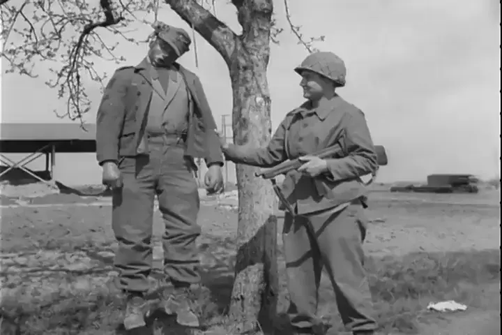 US GI cuts down a German soldier hanging from a tree in 1945