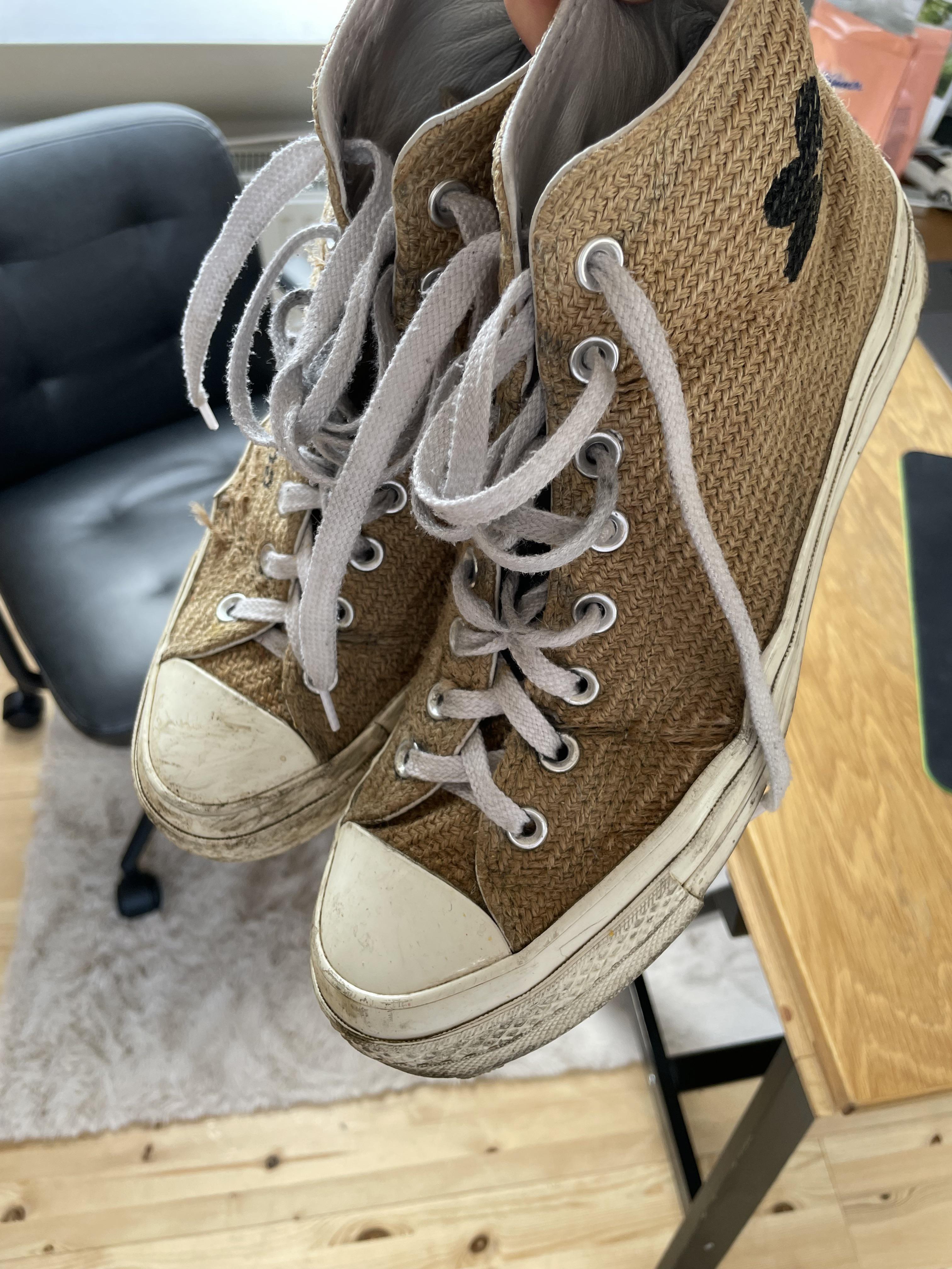 Close-up of a worn-out, dirty tan sneaker sole and side