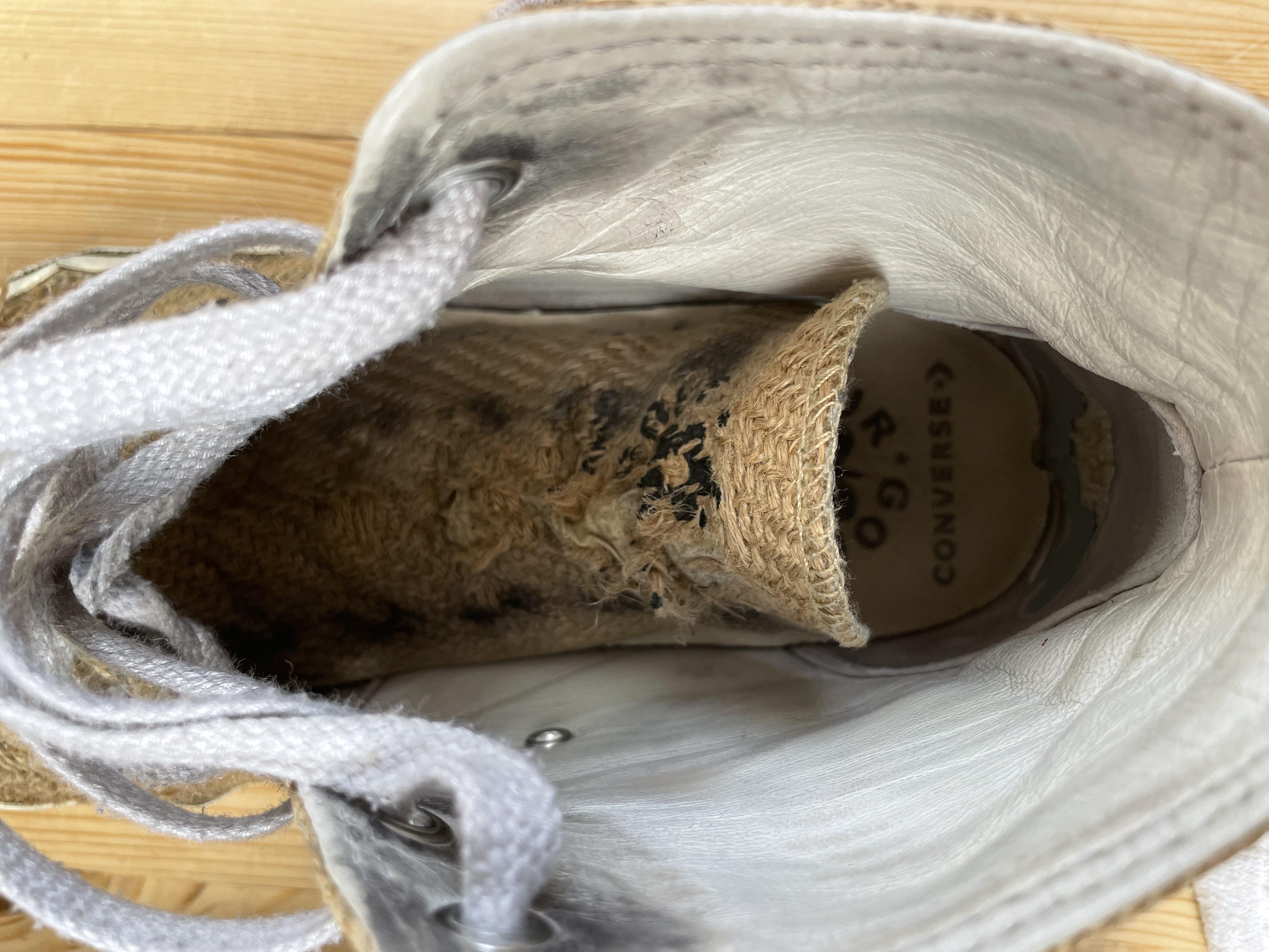 Close-up of a worn-out, dirty tan sneaker sole and side