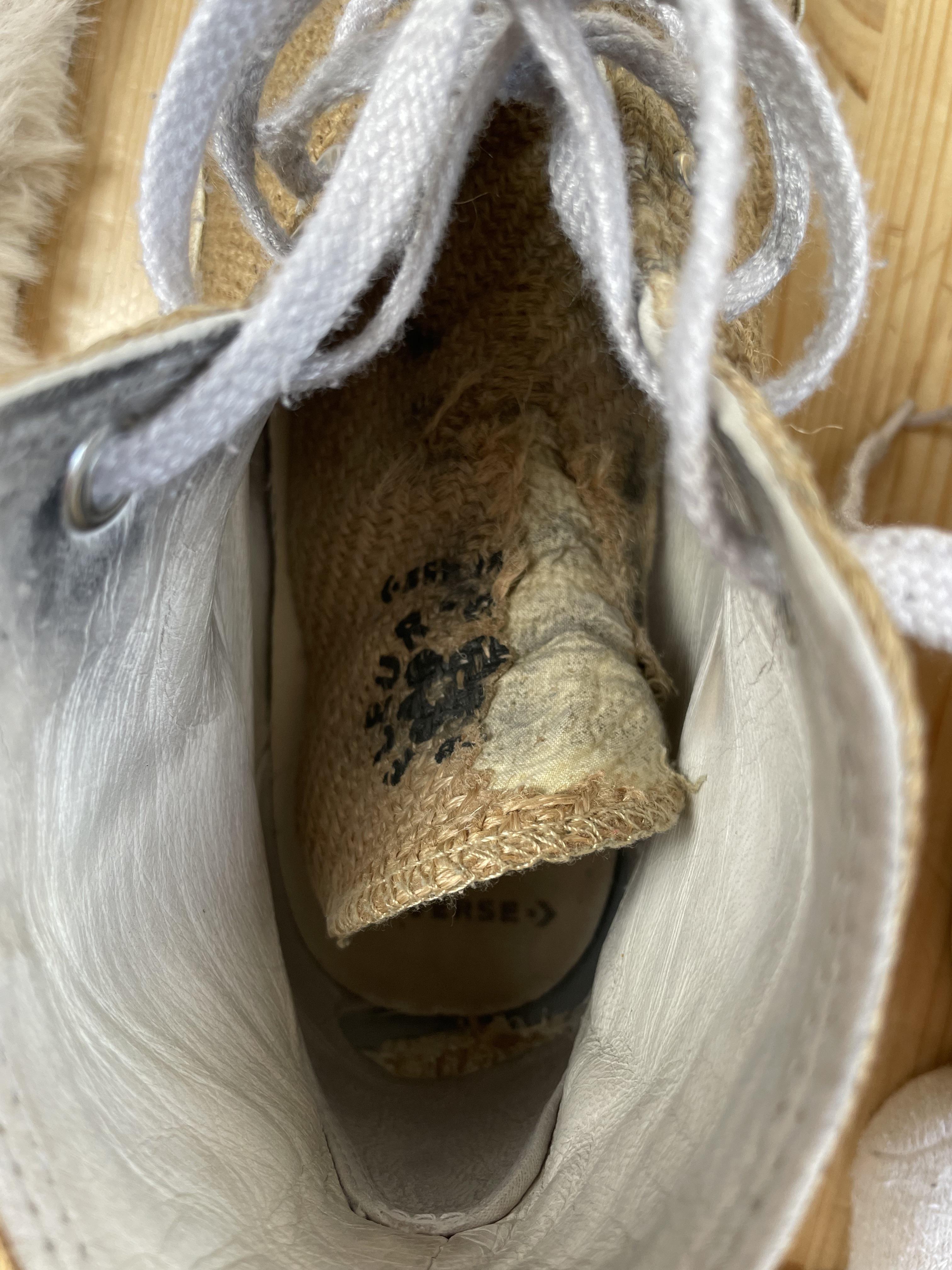 Close-up of a worn-out, dirty tan sneaker sole and side