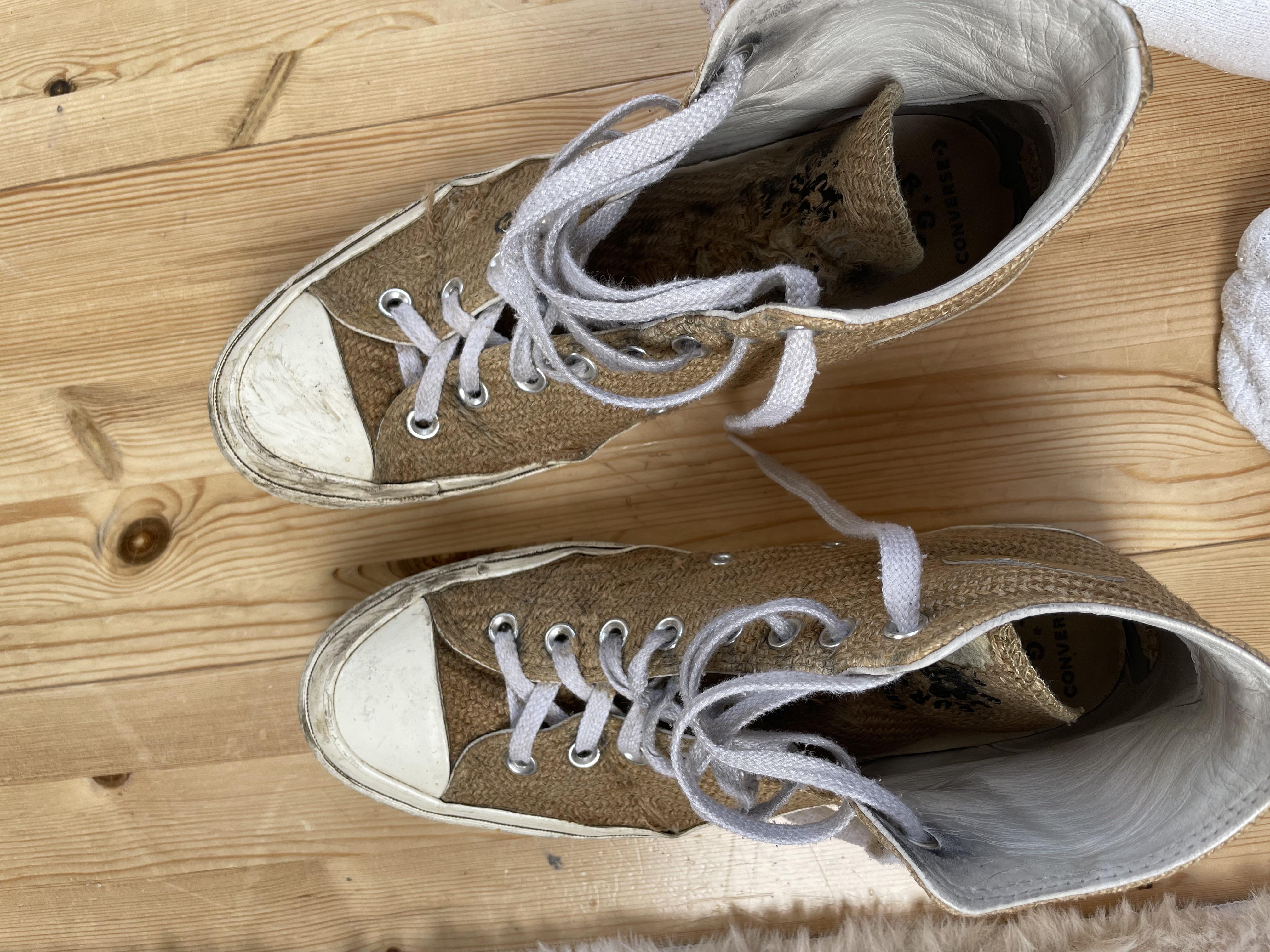 Close-up of a worn-out, dirty tan sneaker sole and side