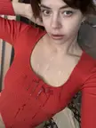 Slim brunette white girl in a red ribbed top with cum on her tits and chest