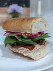Whole grain Dijon mustard tuna salad, bacon, spring mix, tomato, radish, sandwich spread, mustard, salt, pepper, sandwich oil, French bread w/garlic herb 