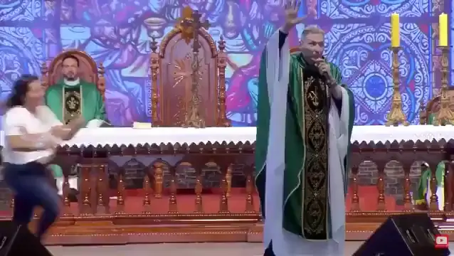 Woman pushes Brazilian priest off the stage during a live broadcast