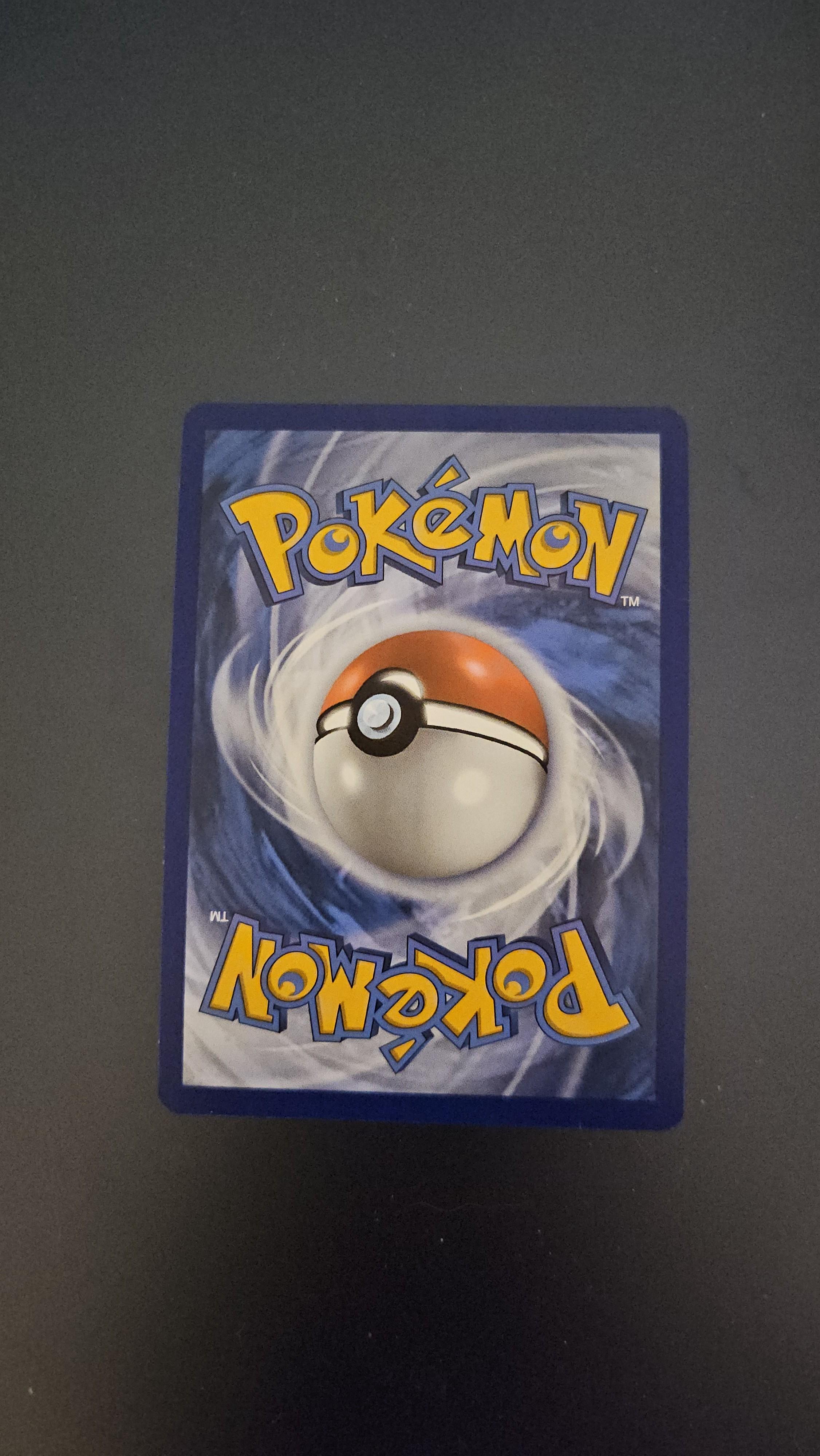 Charizard Pokémon card front and back on a dark surface