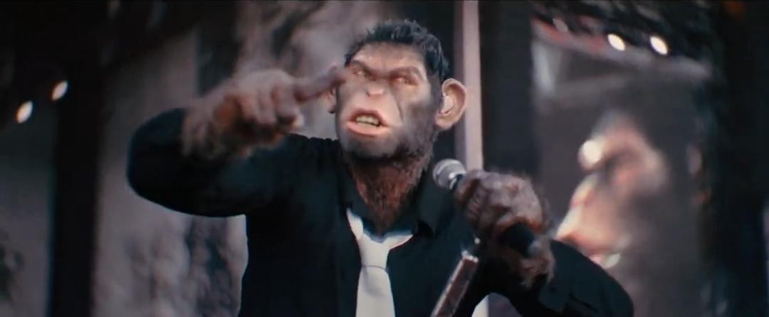 Anthropomorphic chimpanzee in a suit performing with a microphone on a concert stage before a crowd.
