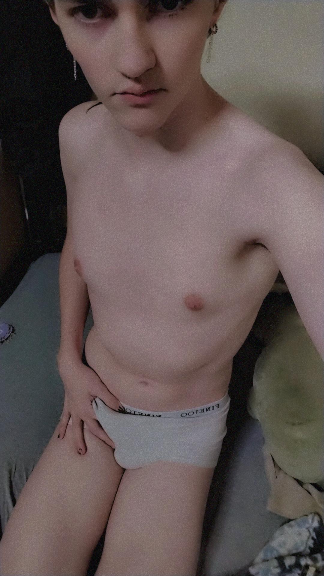 Slim white femboy with brown hair and earrings posing in white cotton panties and naked