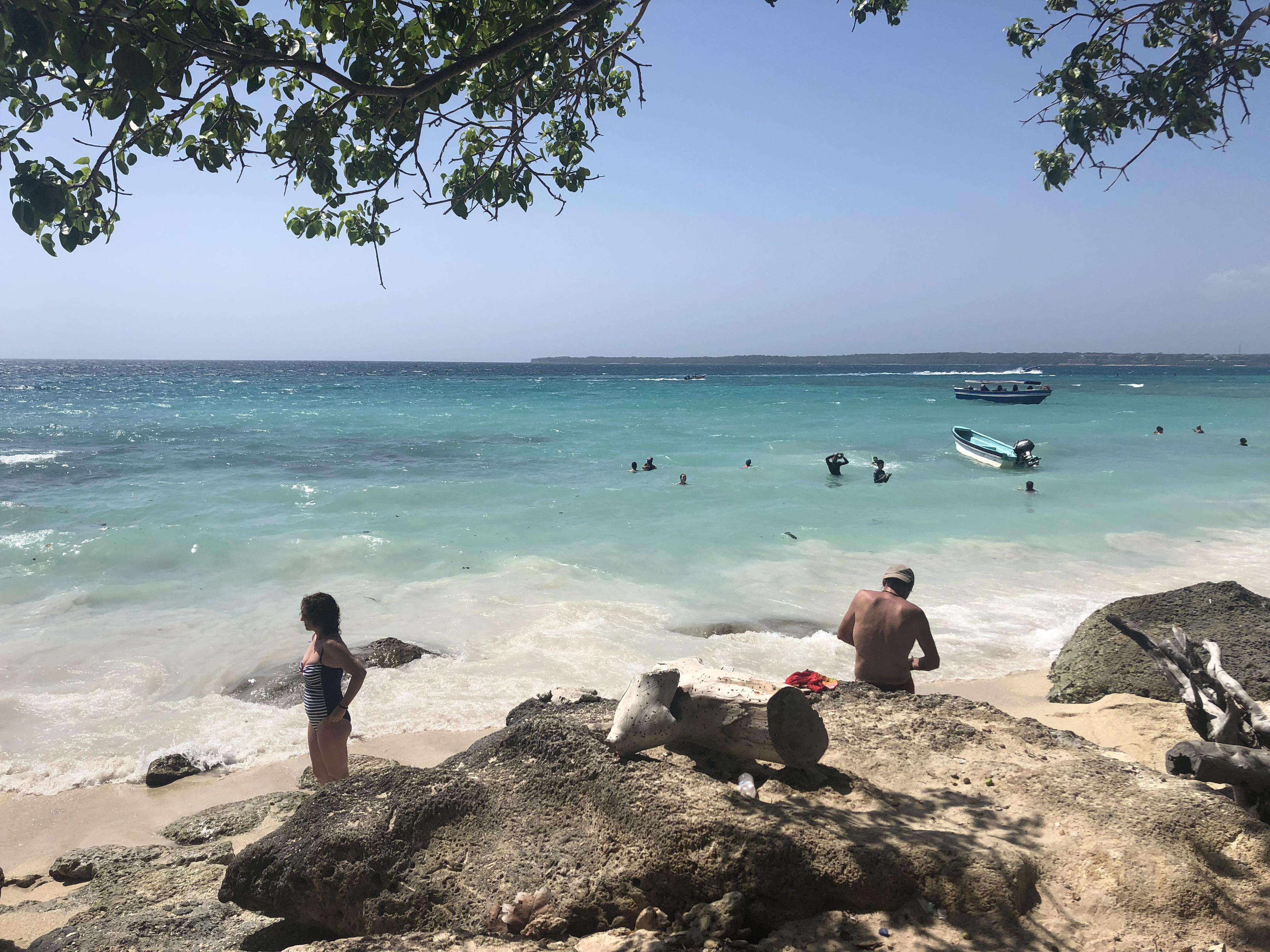 Caribbean coastal town in Colombia featuring beaches, city walls, a church, and night street views