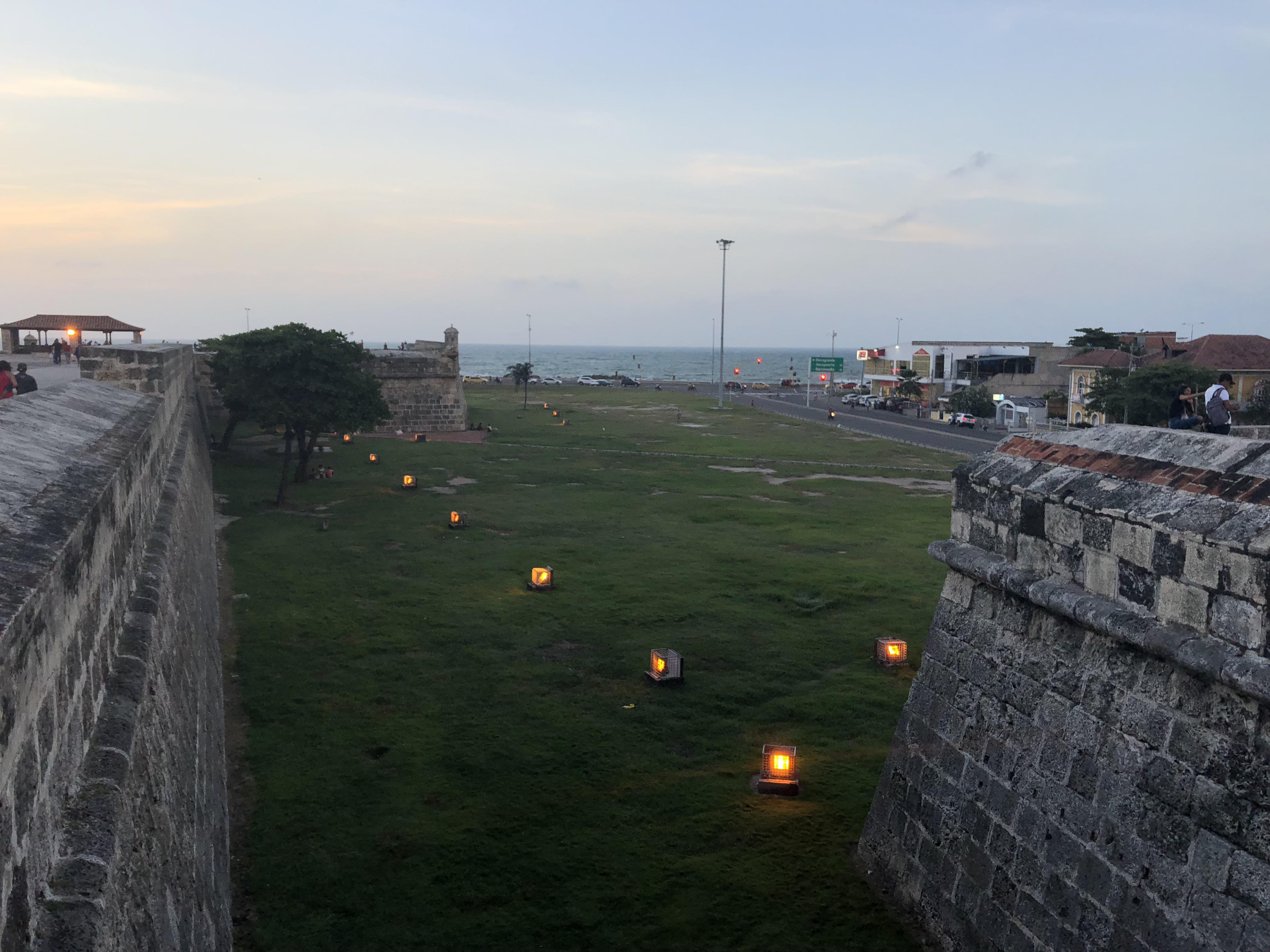 Caribbean coastal town in Colombia featuring beaches, city walls, a church, and night street views