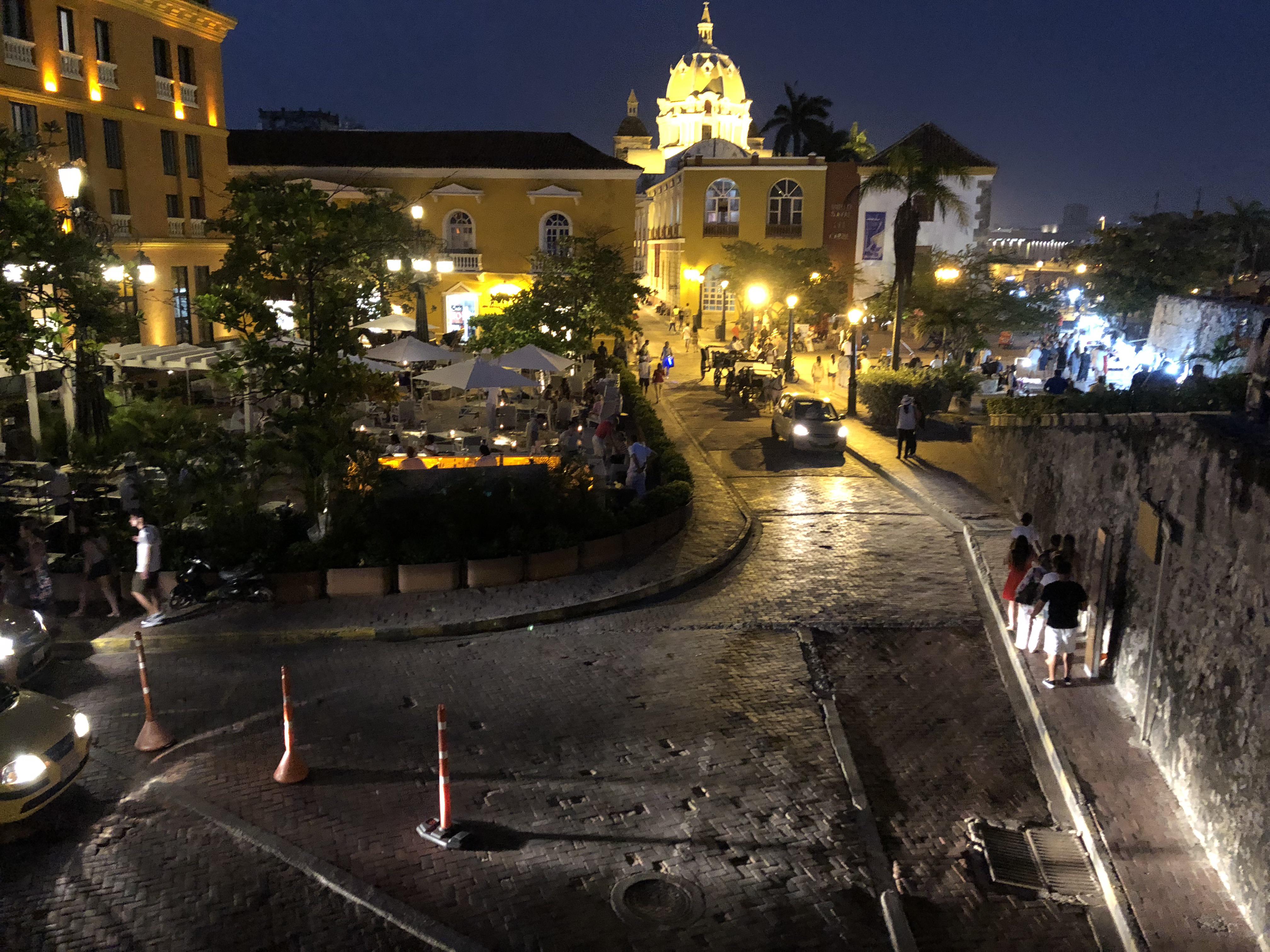 Caribbean coastal town in Colombia featuring beaches, city walls, a church, and night street views