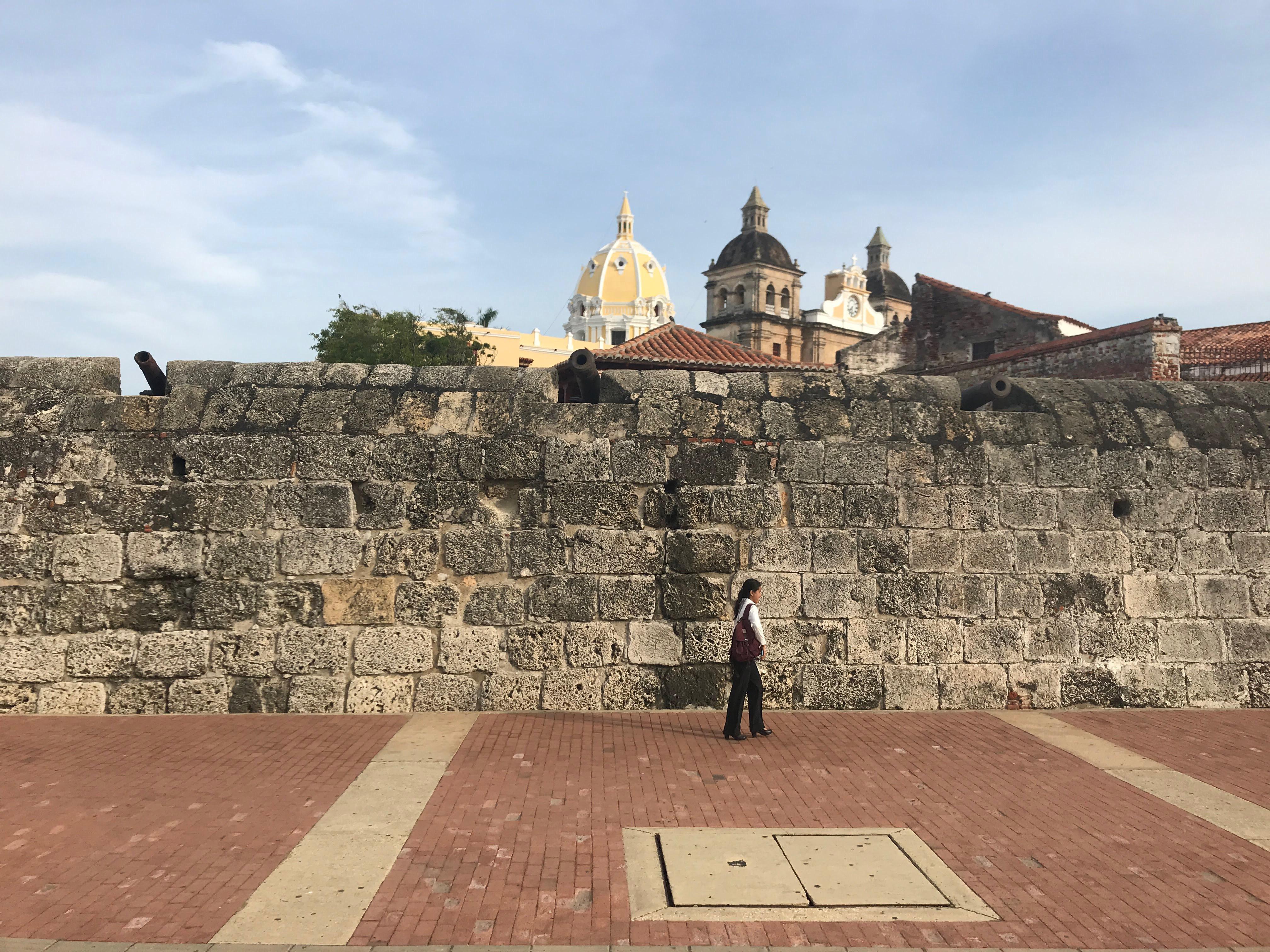Caribbean coastal town in Colombia featuring beaches, city walls, a church, and night street views