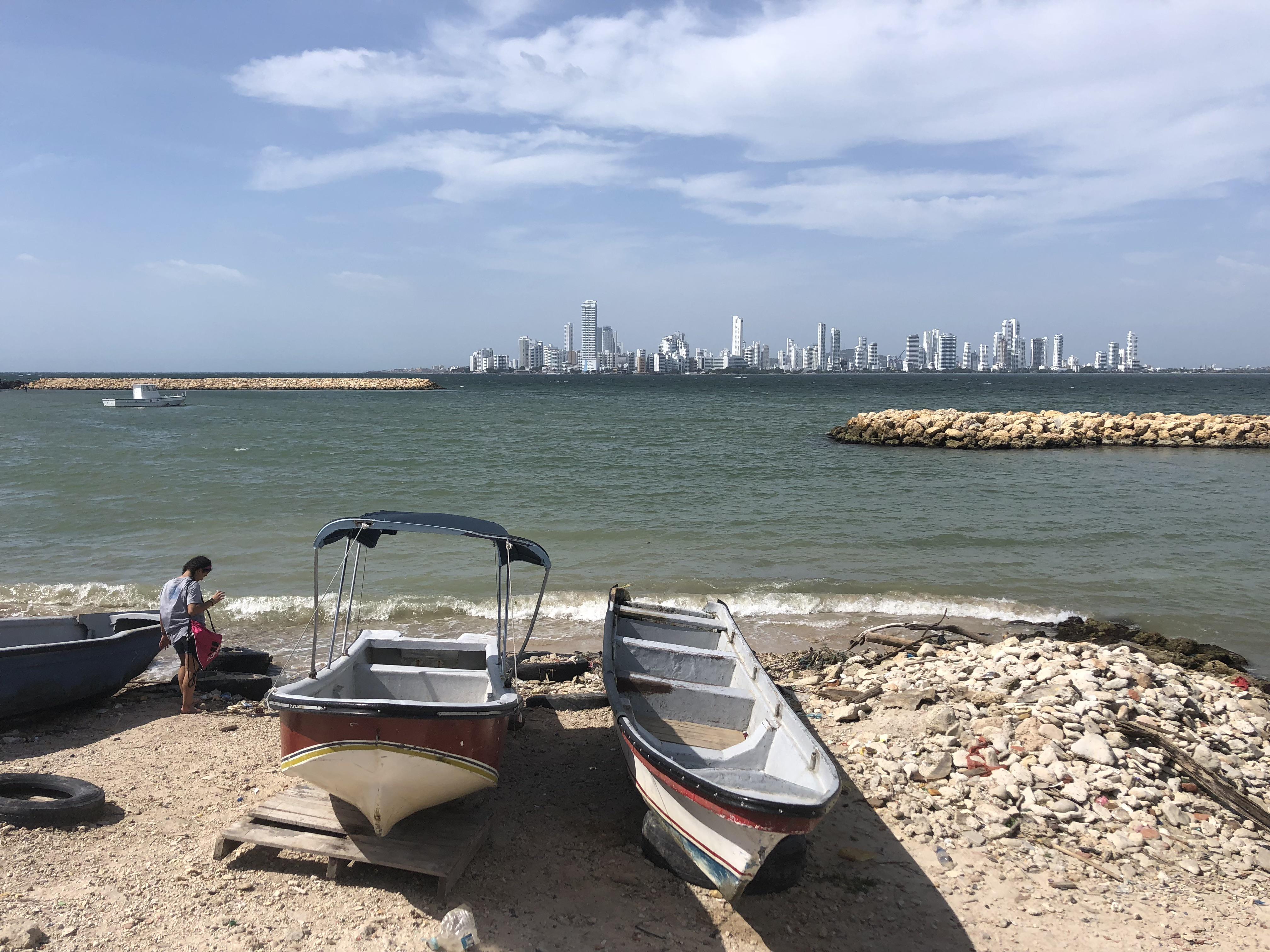 Caribbean coastal town in Colombia featuring beaches, city walls, a church, and night street views