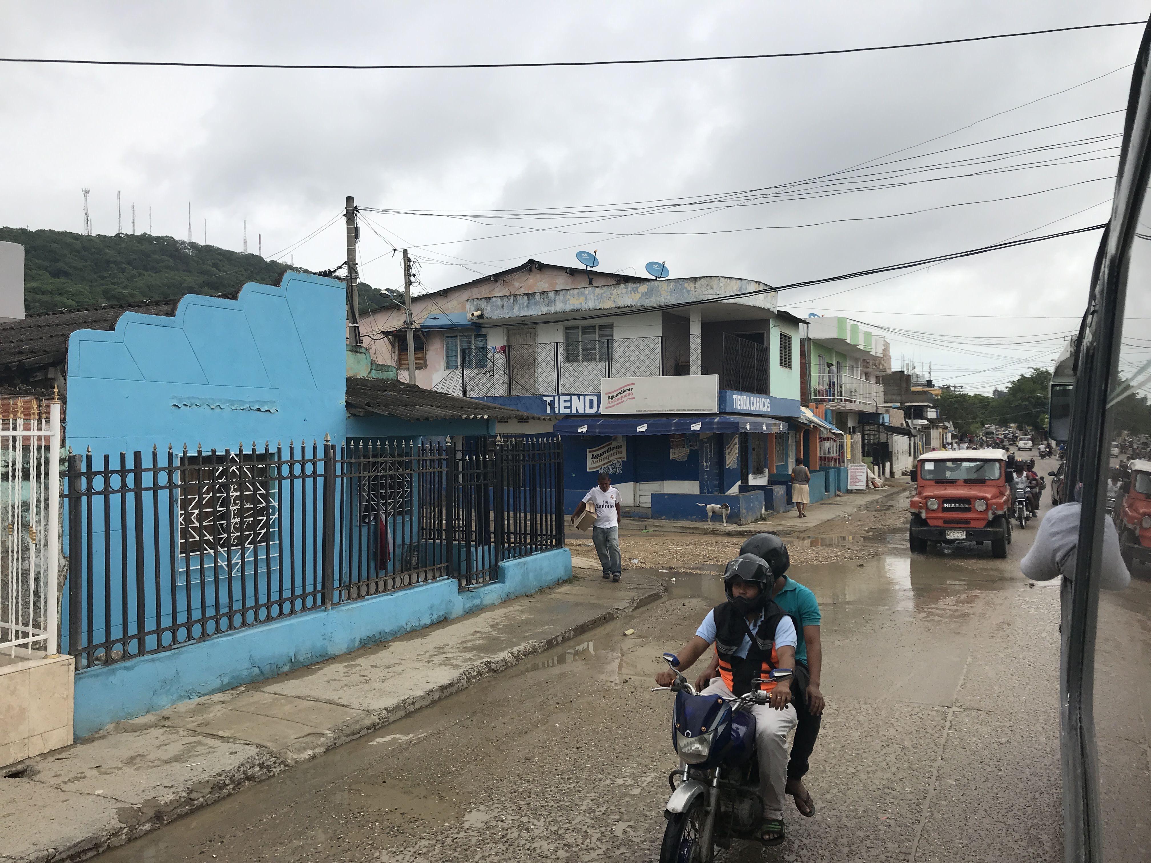 Caribbean coastal town in Colombia featuring beaches, city walls, a church, and night street views